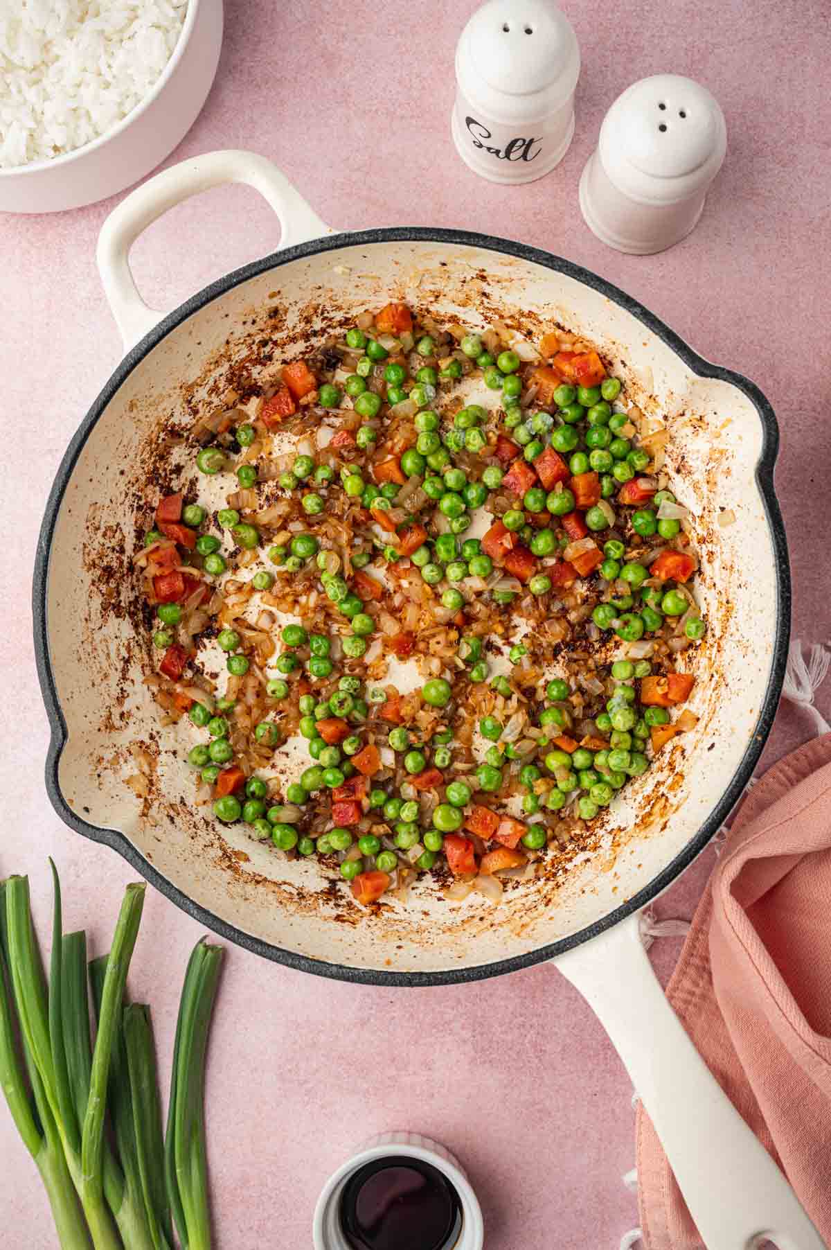 Vegetables cooked in the skillet for chicken and shrimp fried rice.