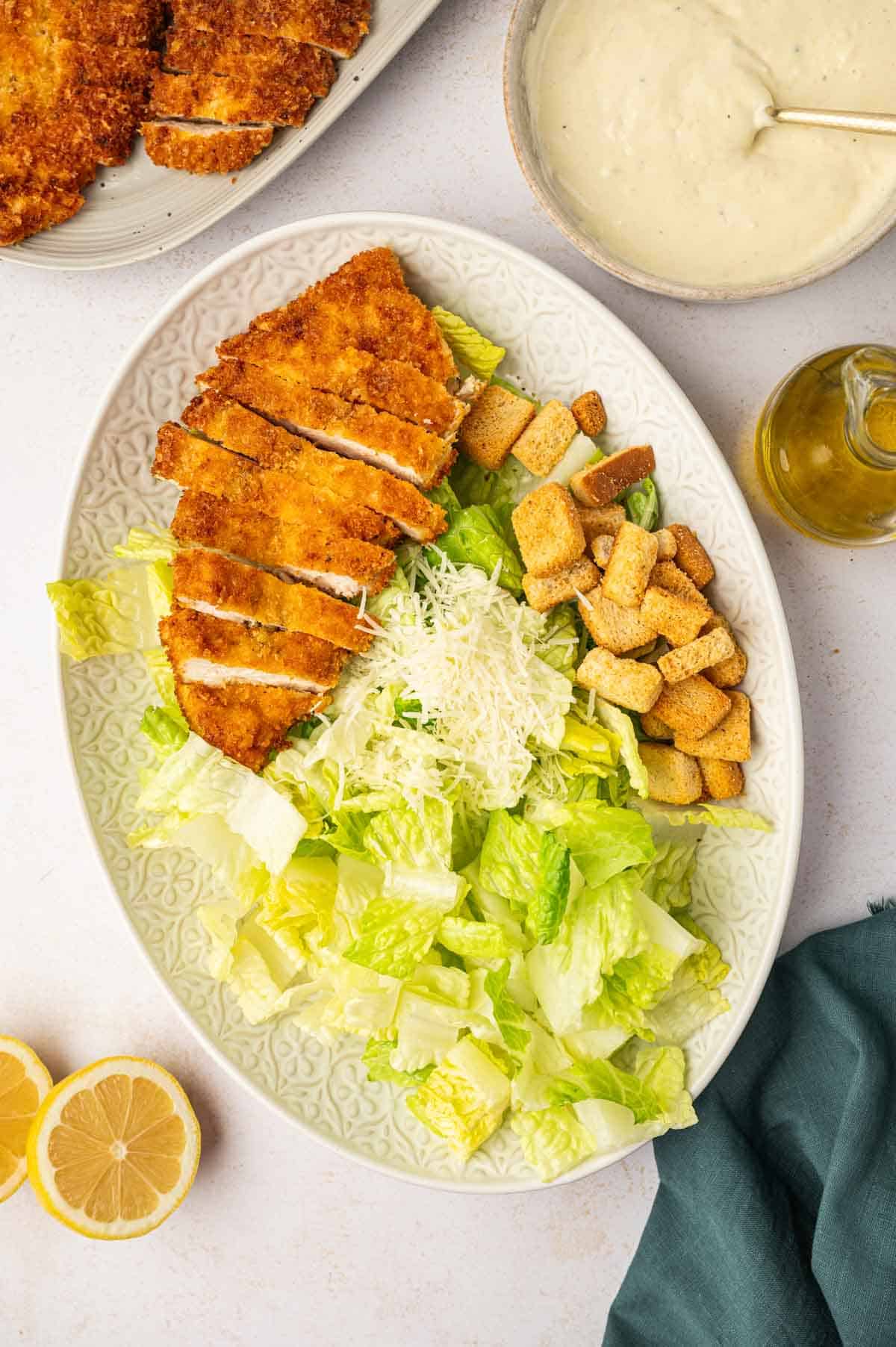 Gathered prepared Caesar Salad ingredients arranged in a serving platter.