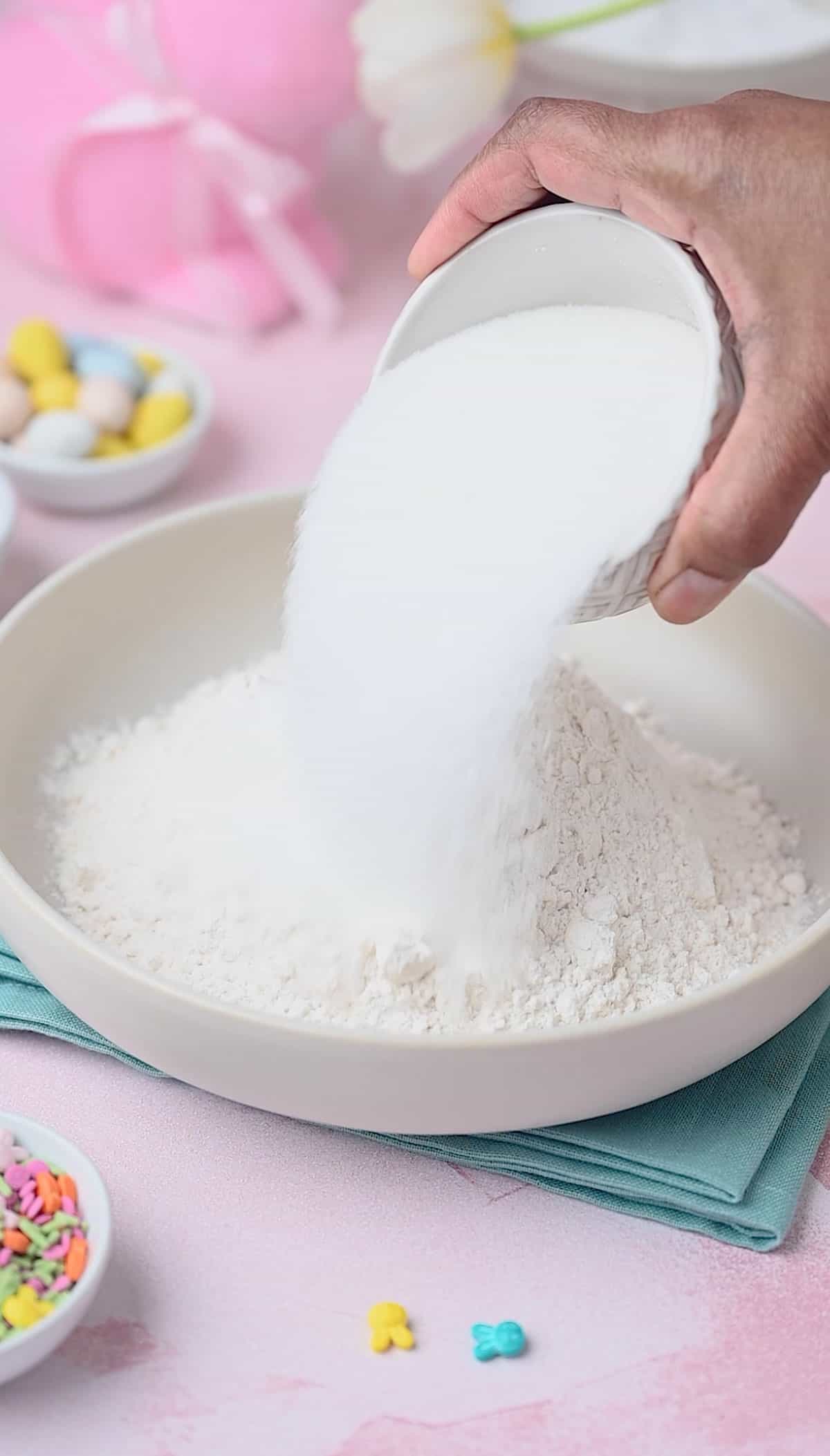 Dry ingredients are being mixed for making easter donuts recipe.