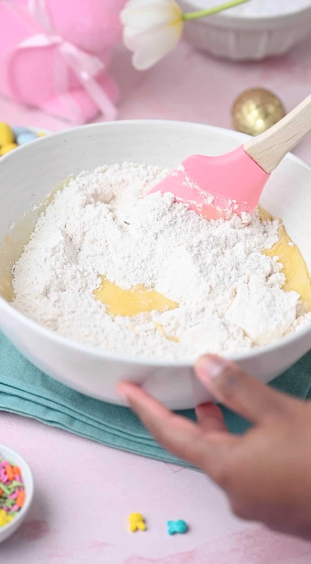 Fold the dry ingredients into the wet mixture for easter donuts recipe.