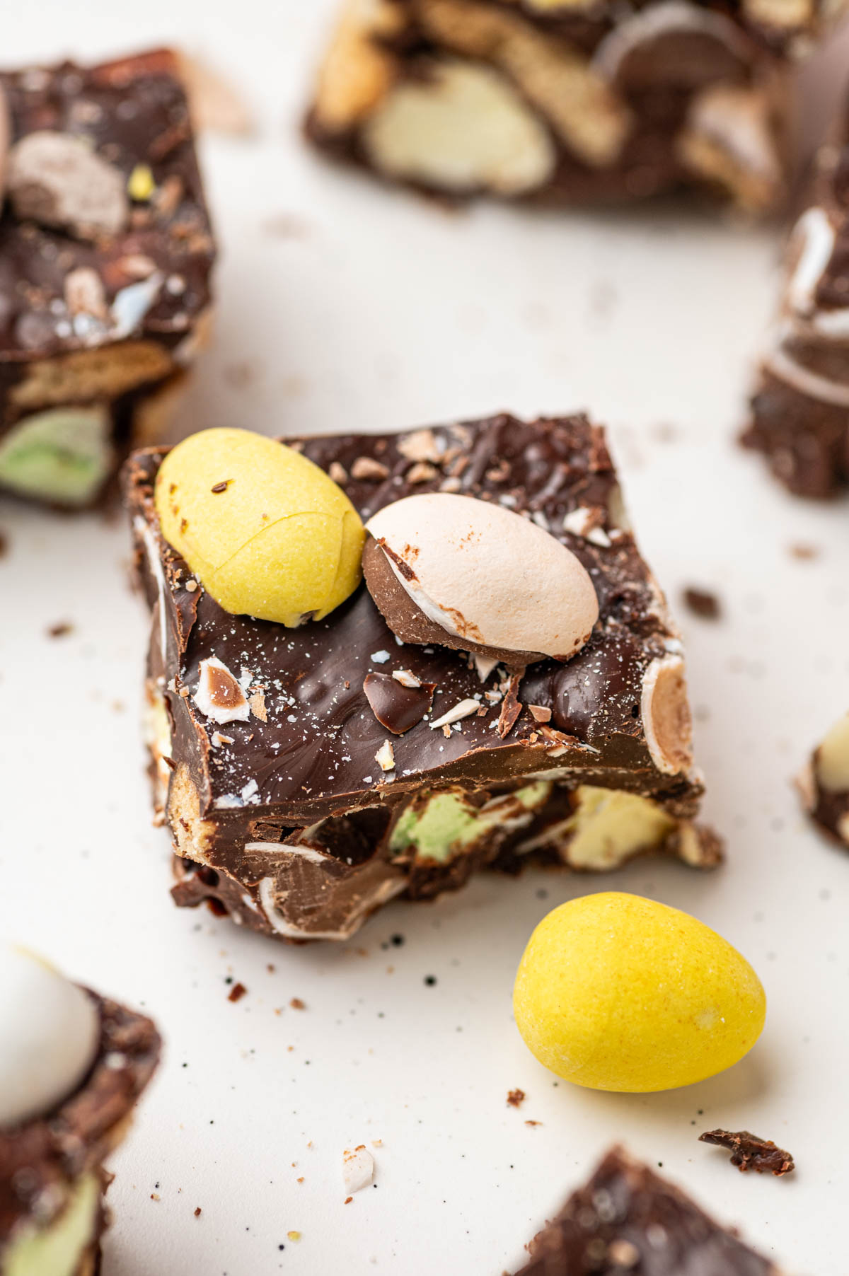 a piece of Easter Rocky Road placed in a white background decorated with mini eggs beautifully.