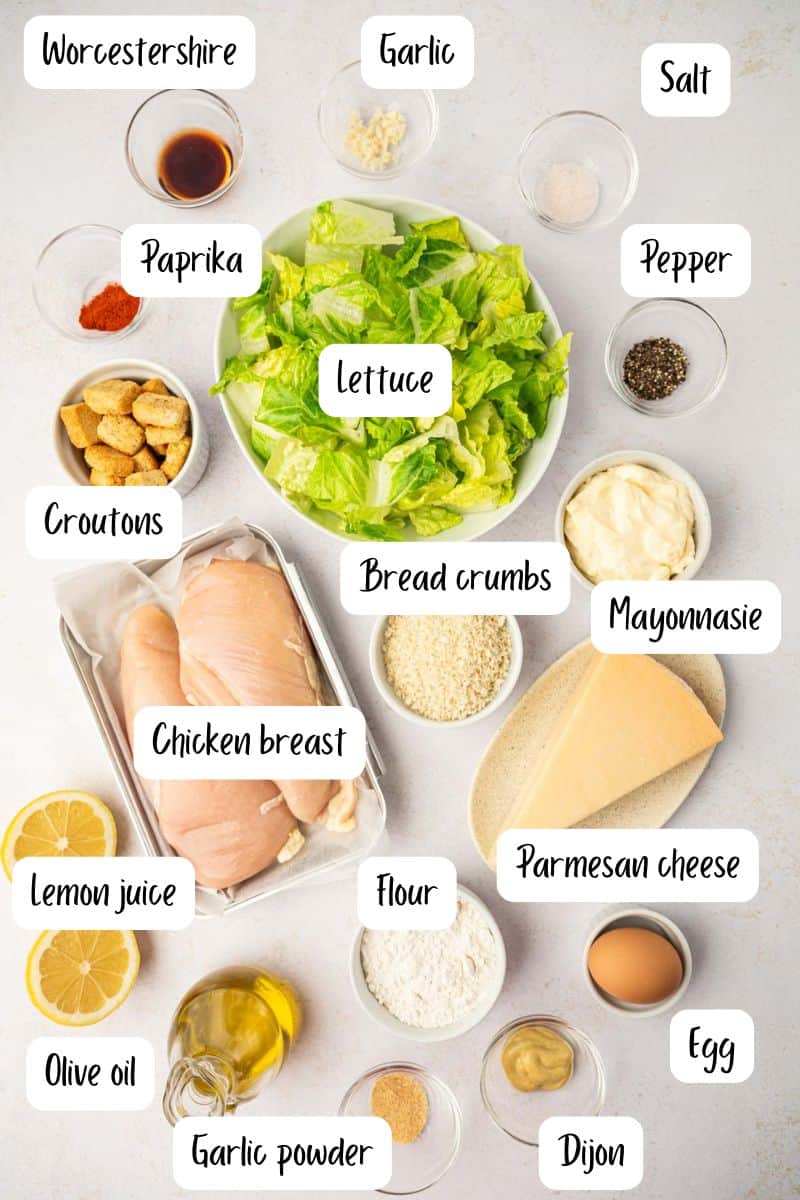 The ingredients laid out for crispy chicken caesar salad with homemade caesar dressing.