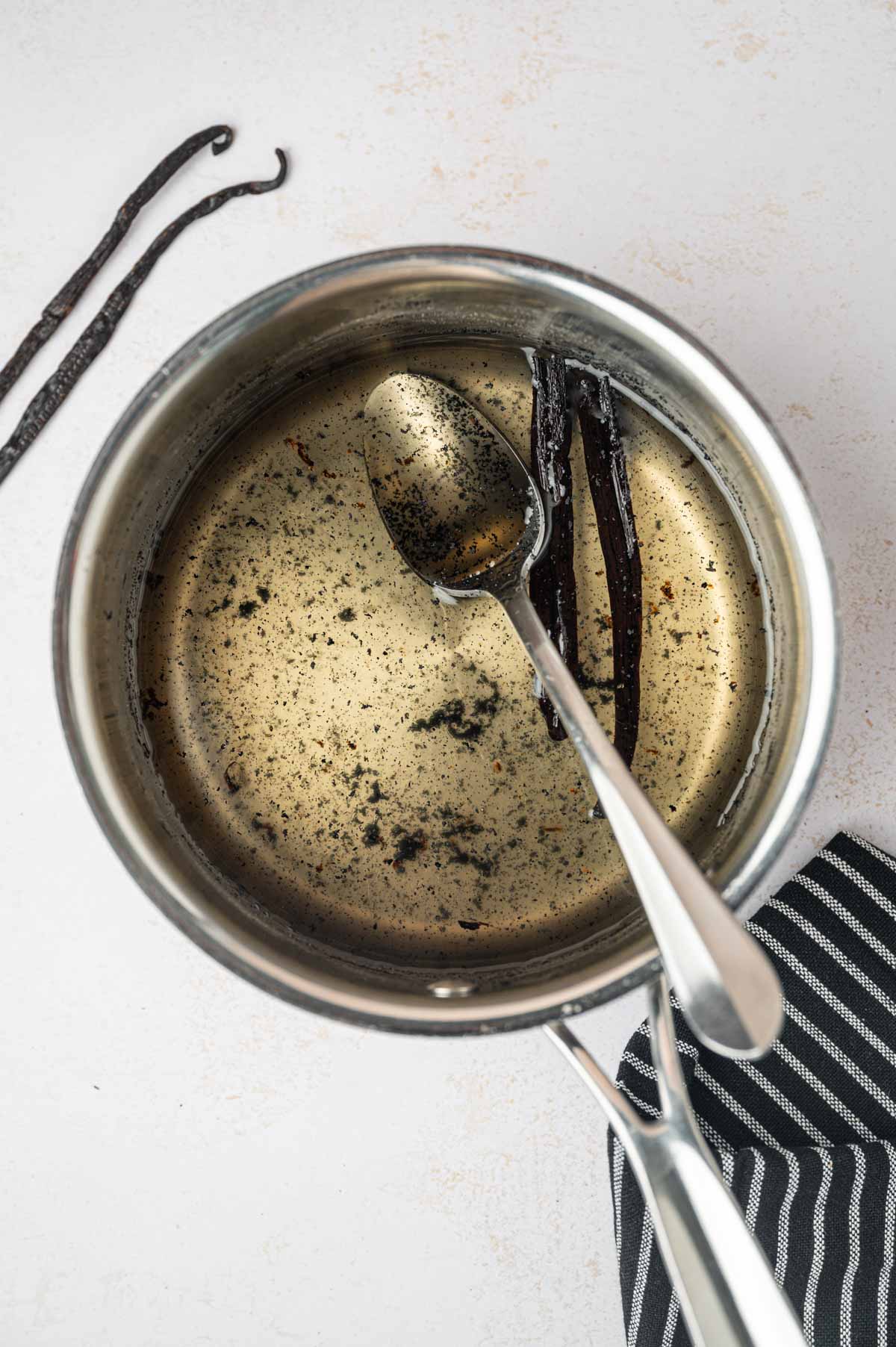 Vanilla bean syrup being simmered in the saucepan.