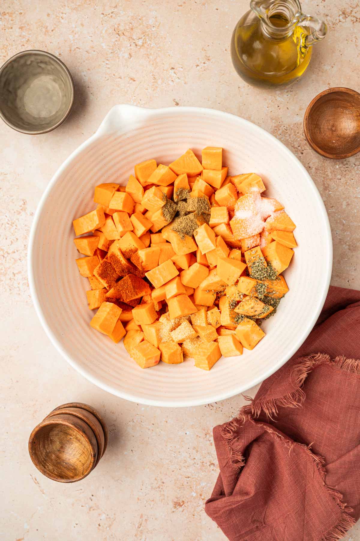 Toss the cubed sweet potatoes in olive oil and seasonings.