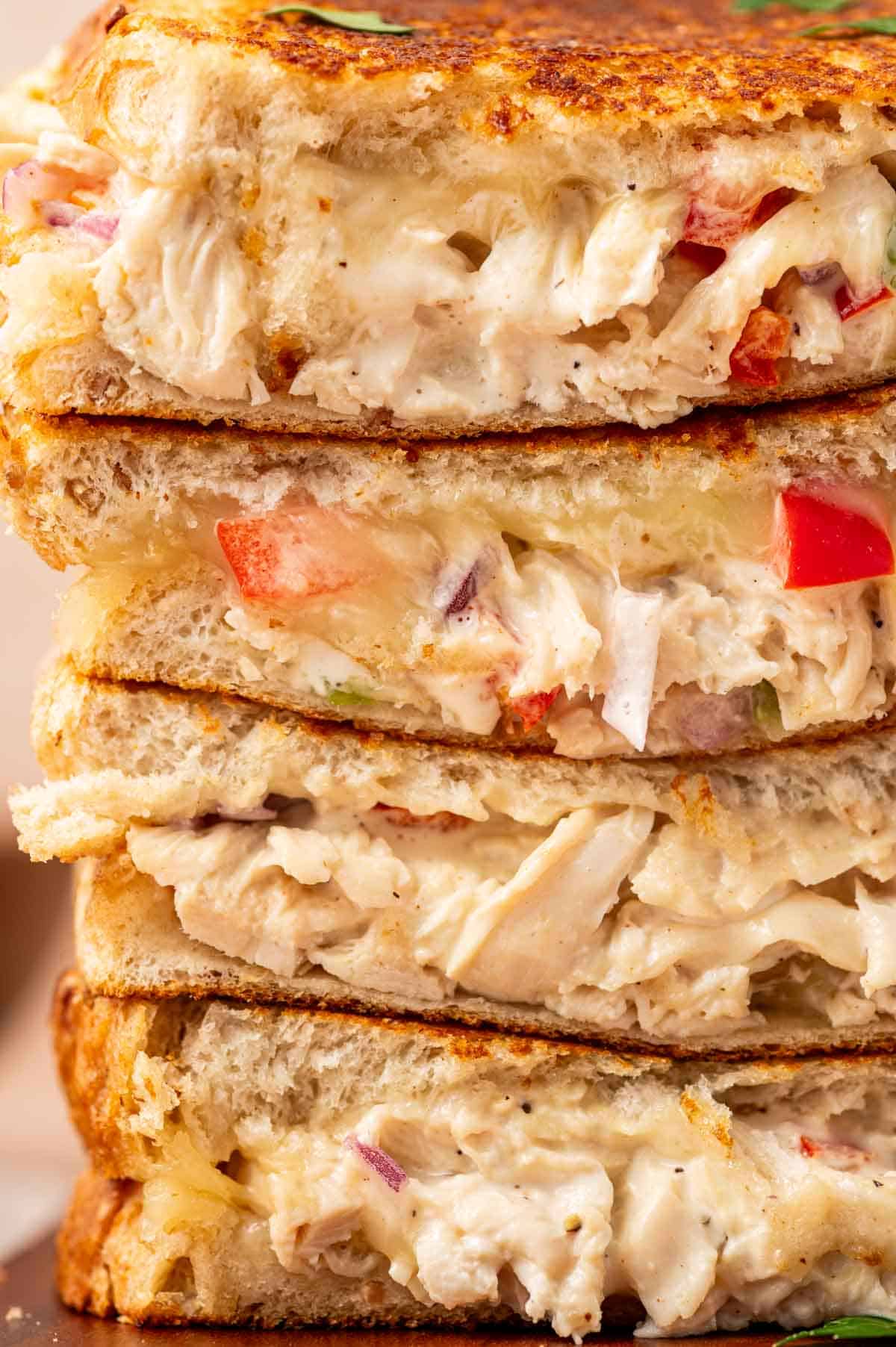 Close-up of a crispy chicken salad melt sandwich with golden toasted bread, melted cheese, and creamy chicken salad filling.