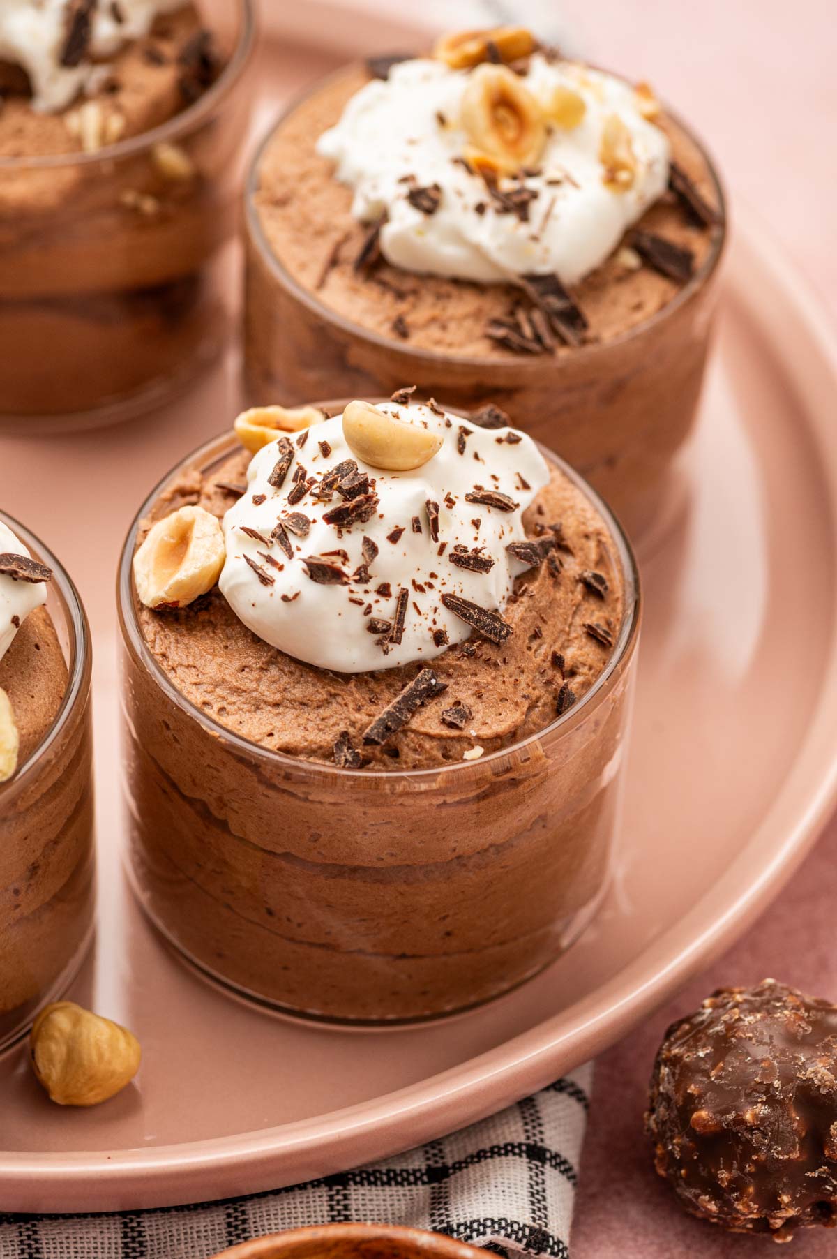 Creamy Nutella mousse in an elegant dessert glass, garnished with a swirl of whipped cream.