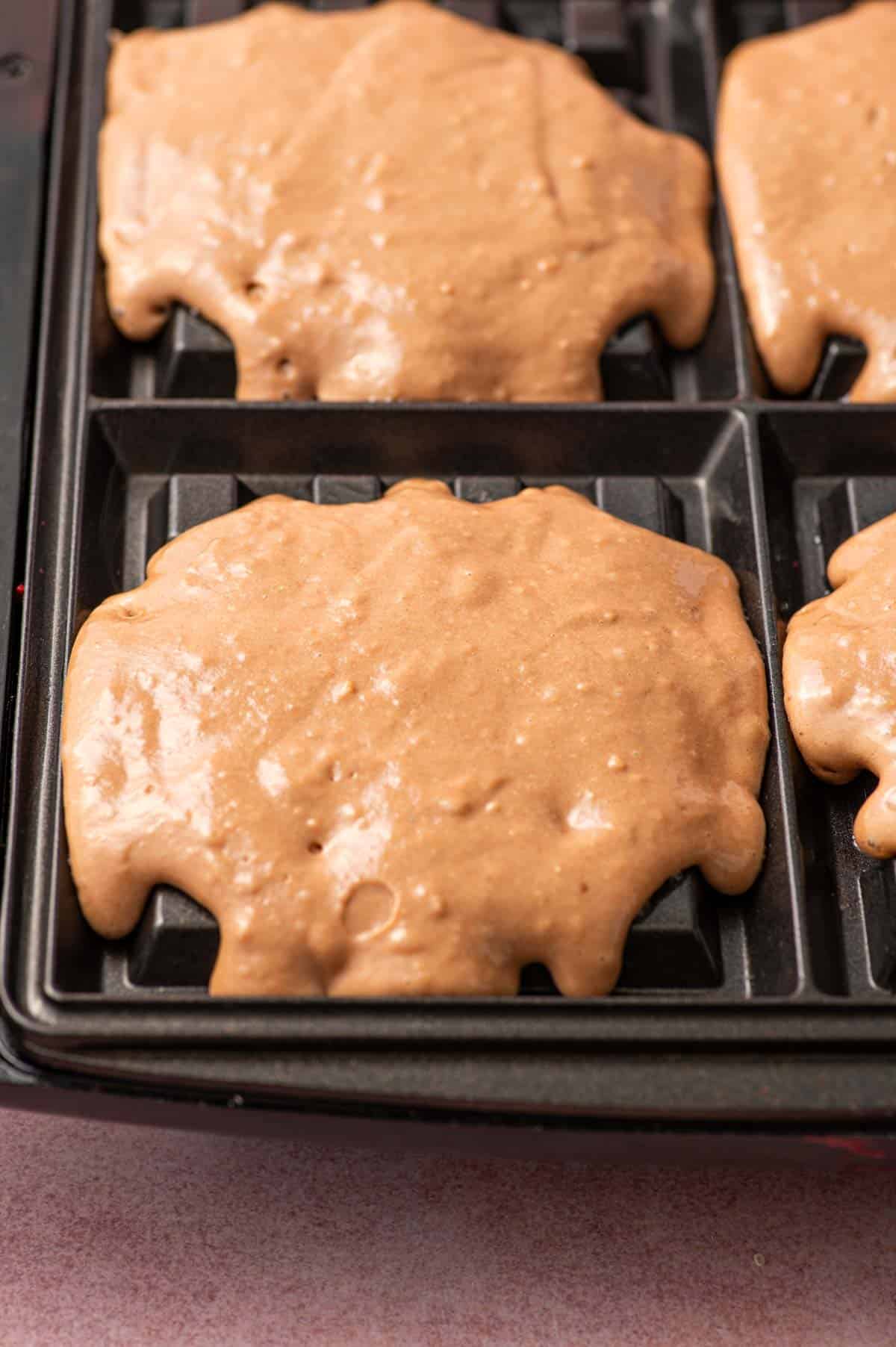 Pour the nutella waffle batter in a waffle maker.