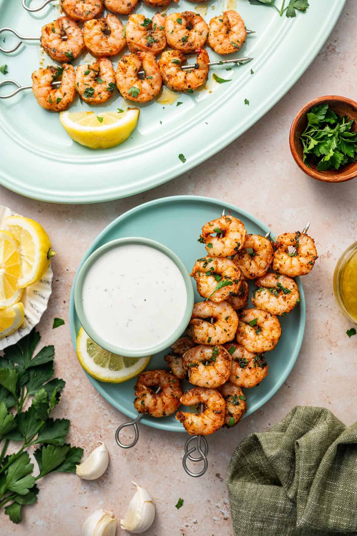 Overhead shot of baked shrimp skewers served with a side of creamy Parmesan Ranch Dip.