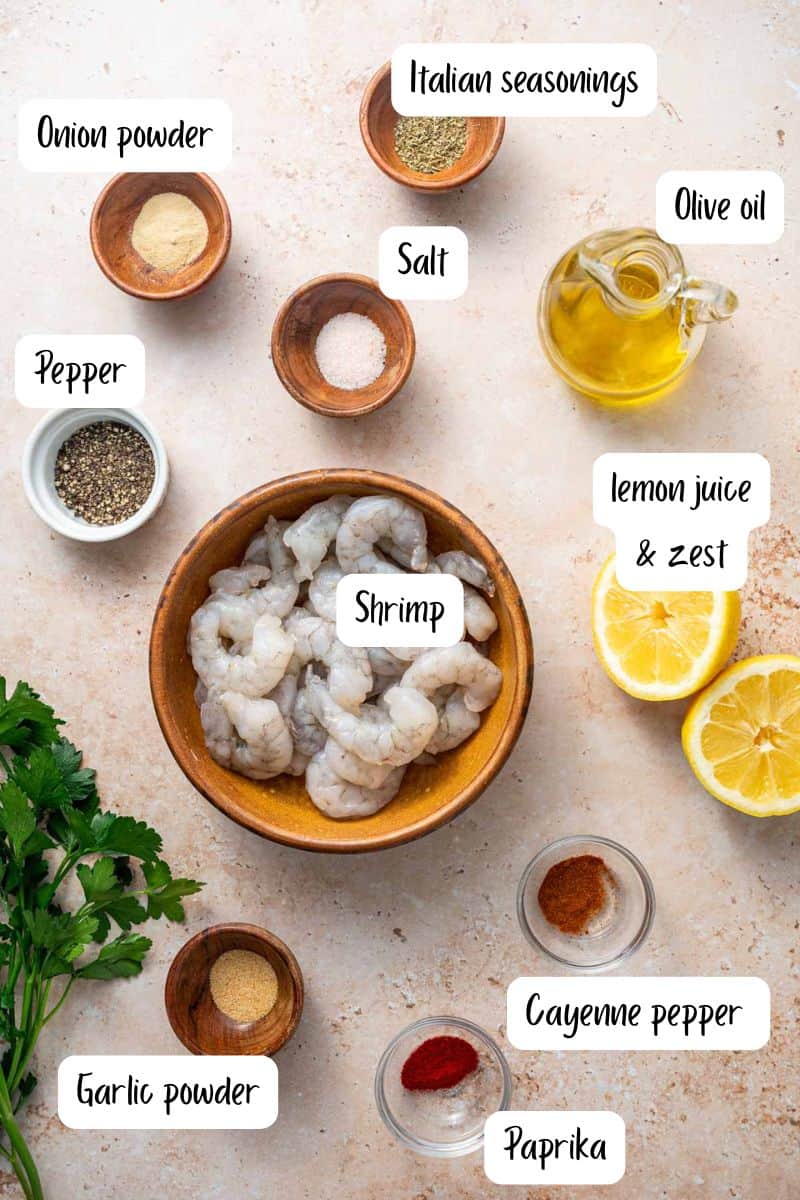 Oven-roasted shrimp skewers ingredients laid out on a warm backdrop before making the recipe.