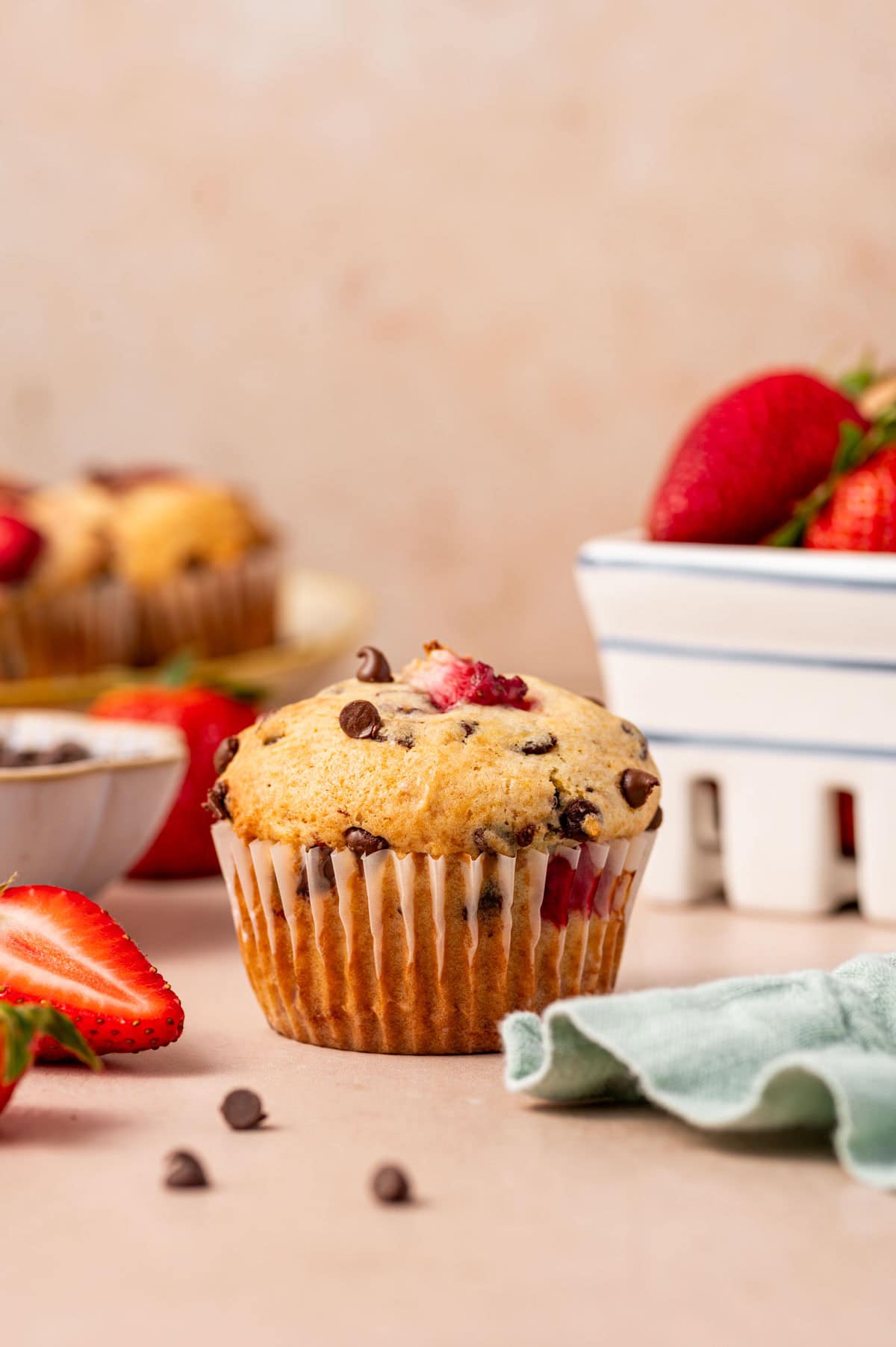 Close-up of a moist strawberry muffin with melted mini chocolate chips.