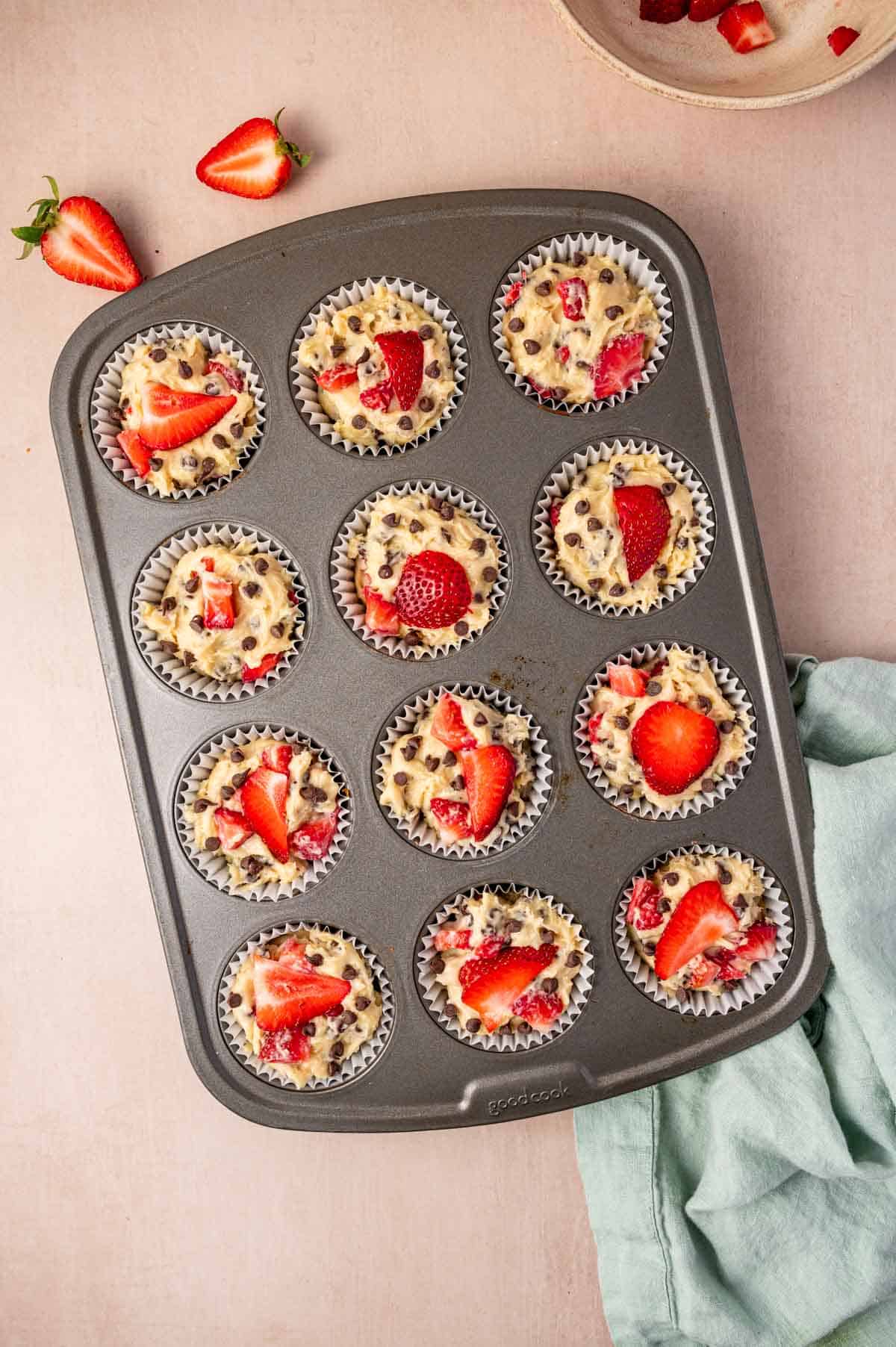 The strawberry chocolate muffins are ready in the muffin pan to bake.