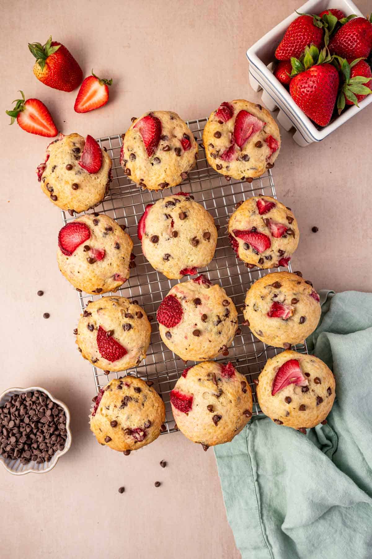 Strawberry chocolate chip muffins are placed in a cooling rack.