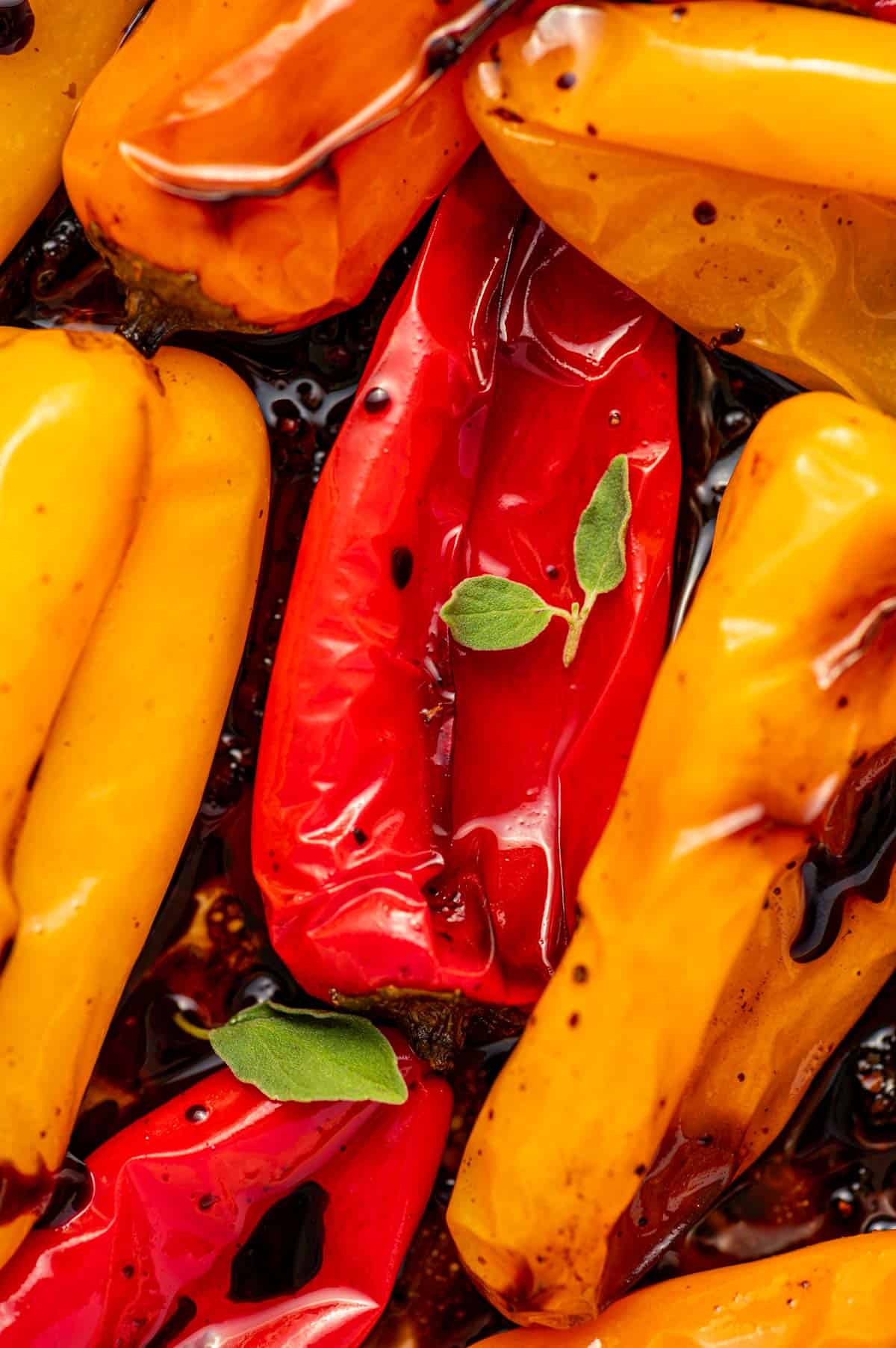 Close-up overhead shot of roasted sweet peppers seasoned with balsamic and oregano.