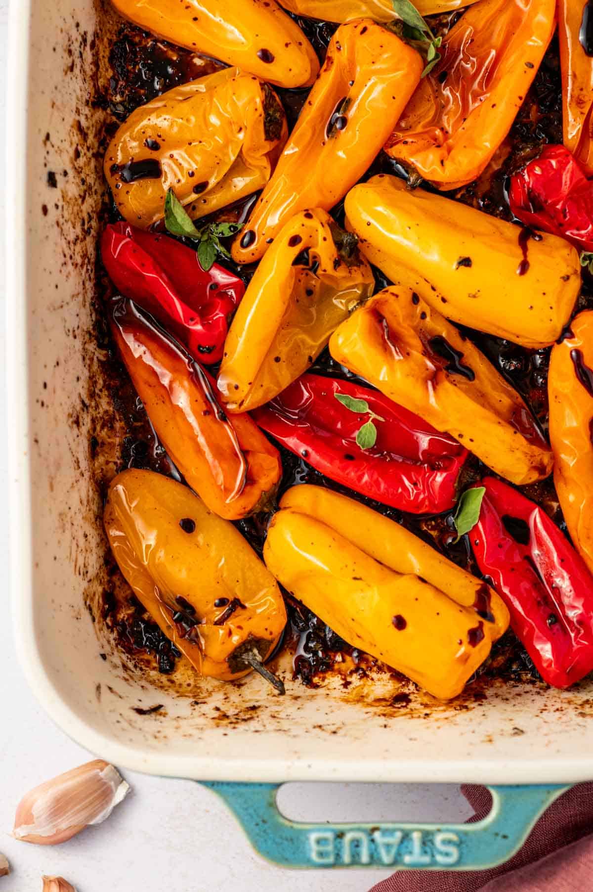 Colorful sweet peppers roasted until blistered and caramelized in a baking dish.