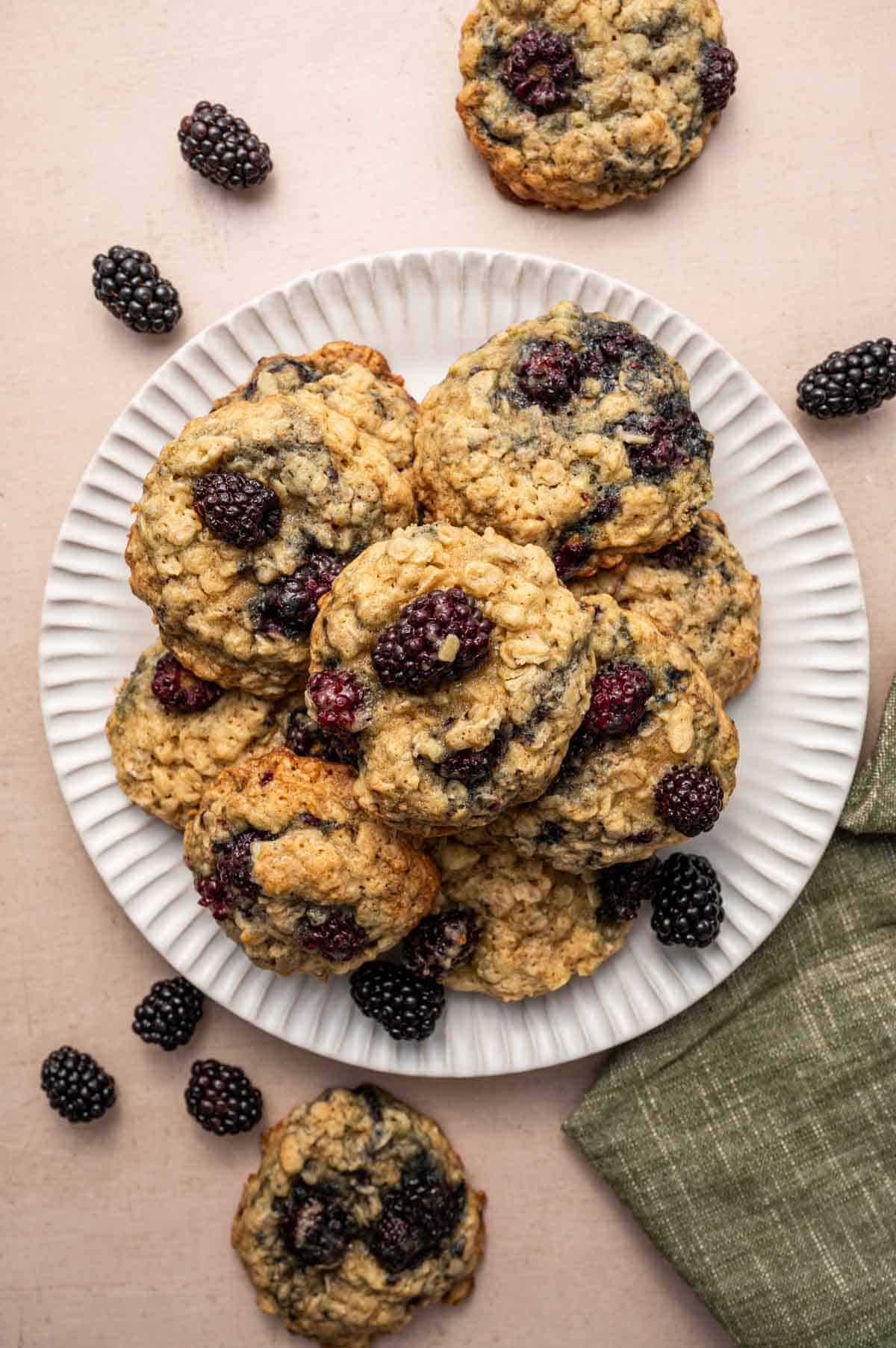 Stack of blackberry oatmeal cookies on a white plate.