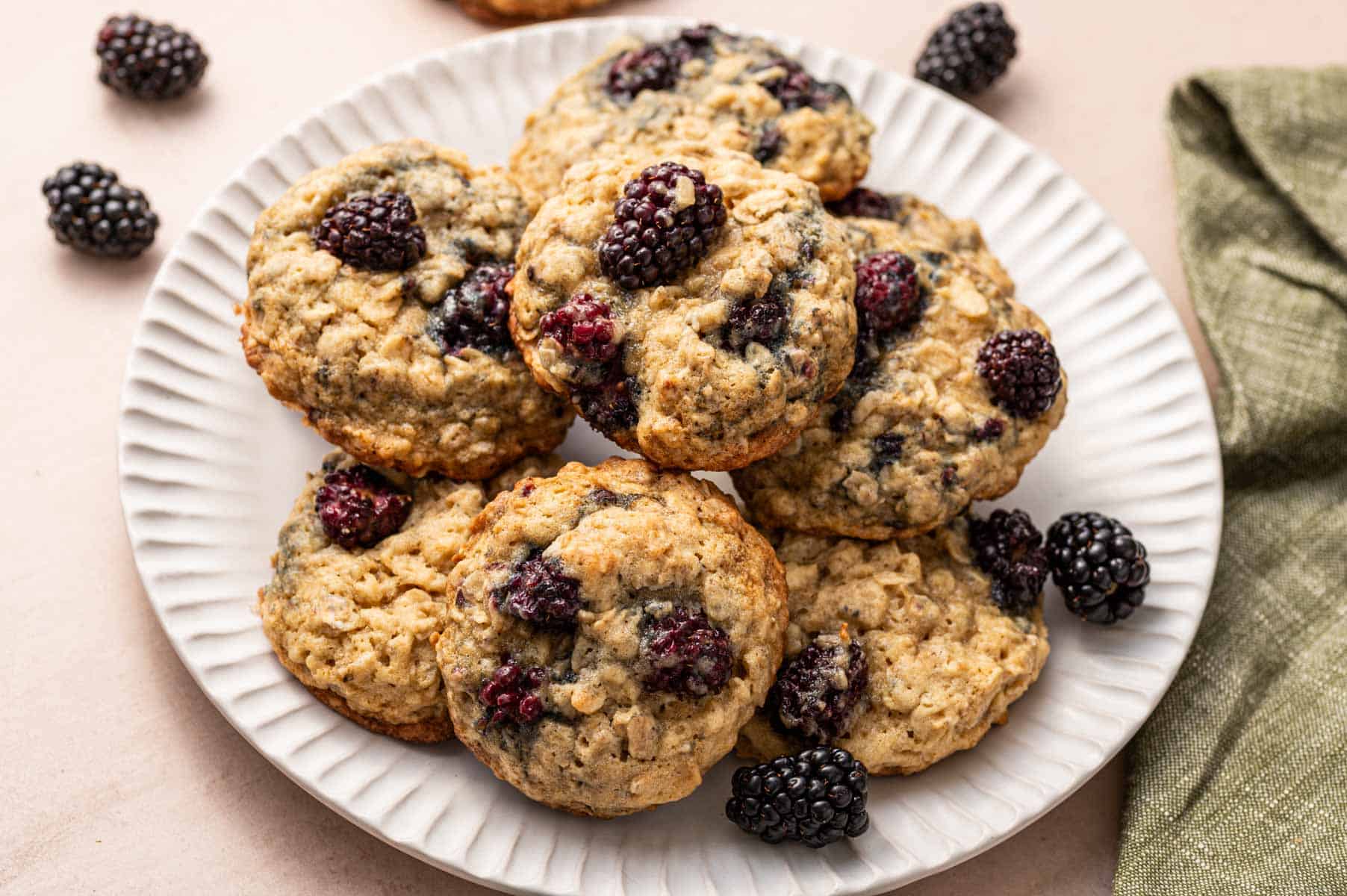 Stack of blackberry oatmeal cookies on a white plate.