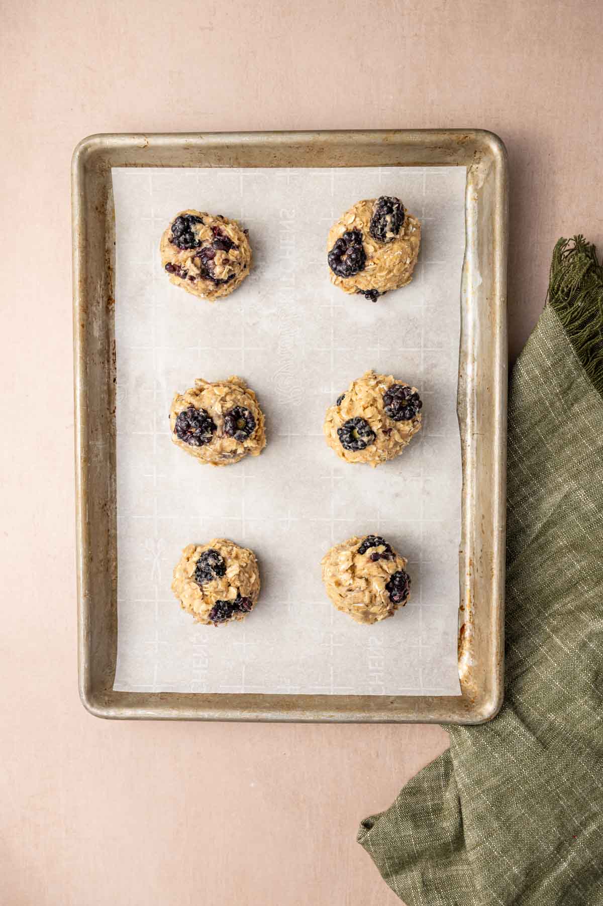 Cookies being scooped into the baking sheet.