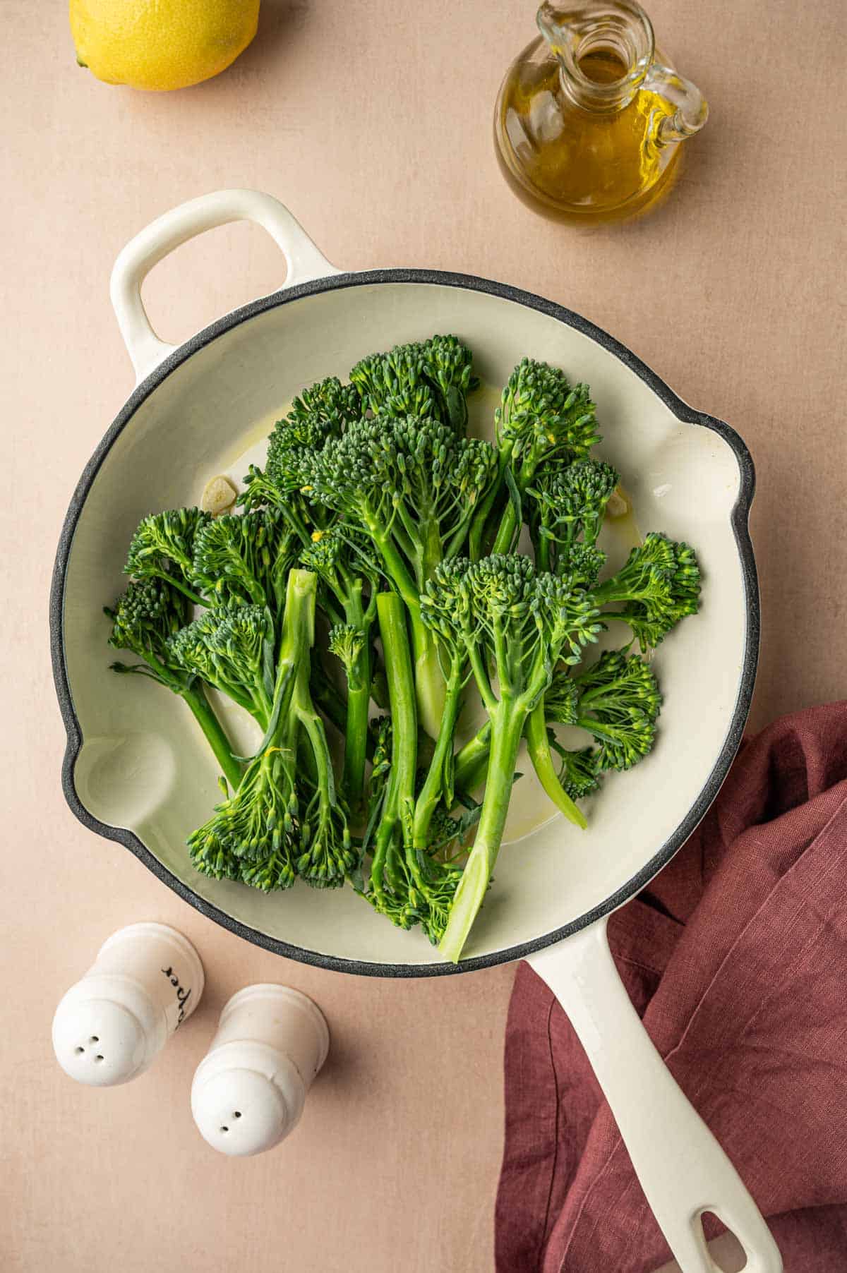 Baby broccoli is added to the skillet.