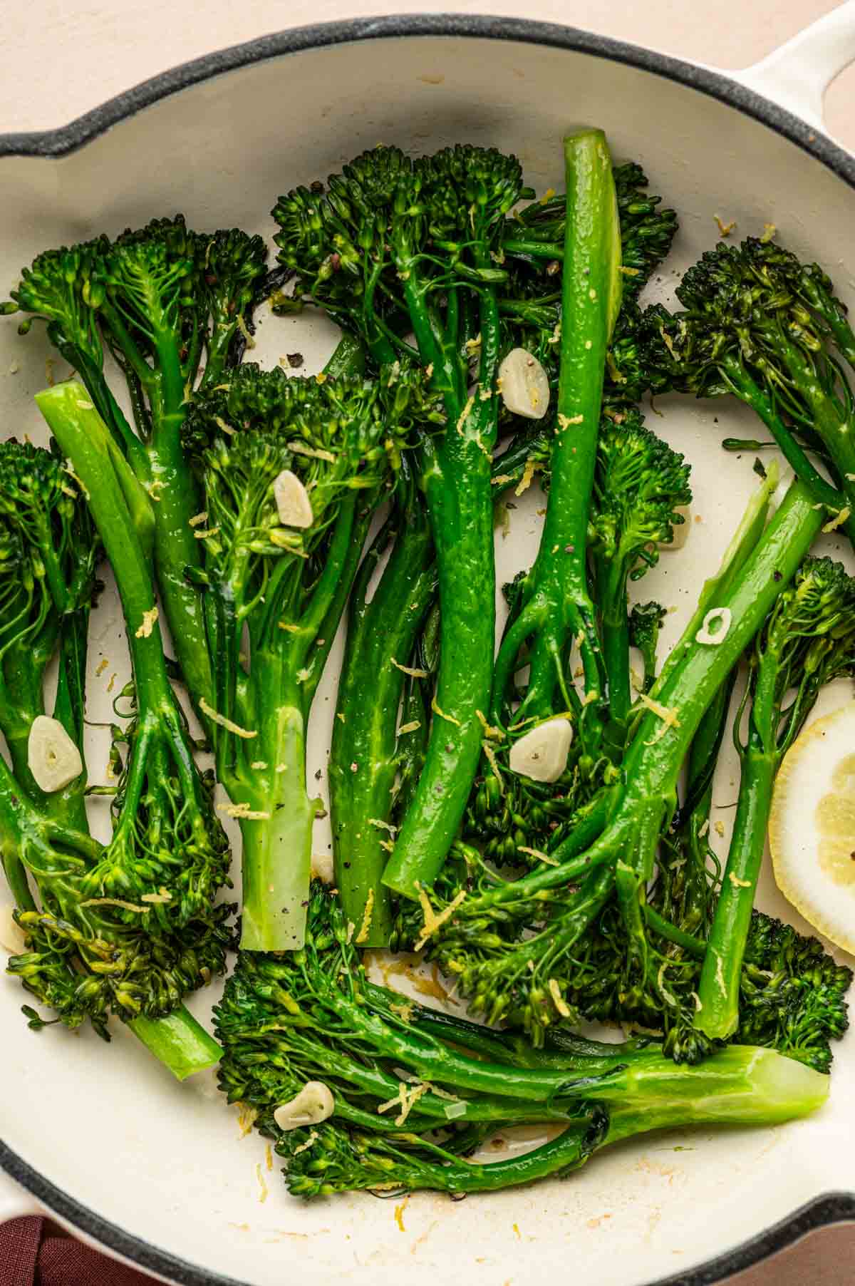 Healthy sautéed broccoletti served as a side dish with pasta in a skillet