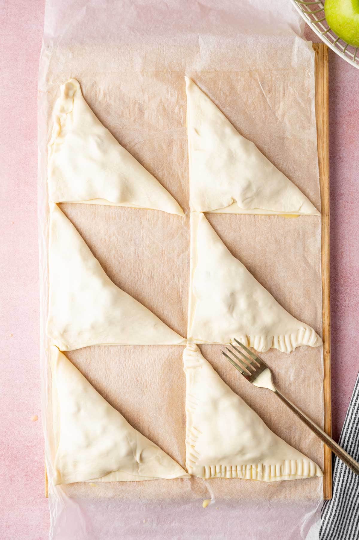 Close the puff pastry triangle.
