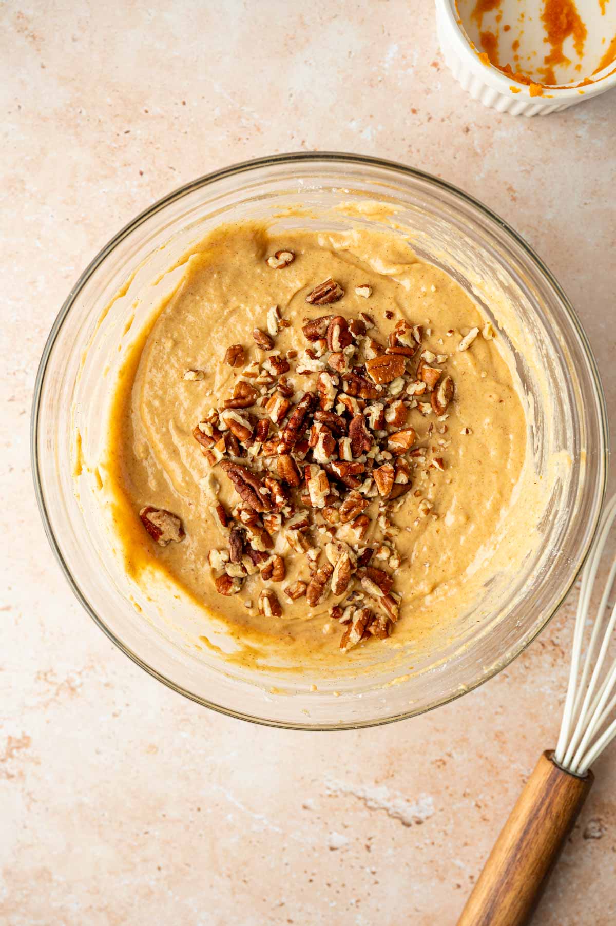 Adding chopped pecans to the pumpkin waffle batter.