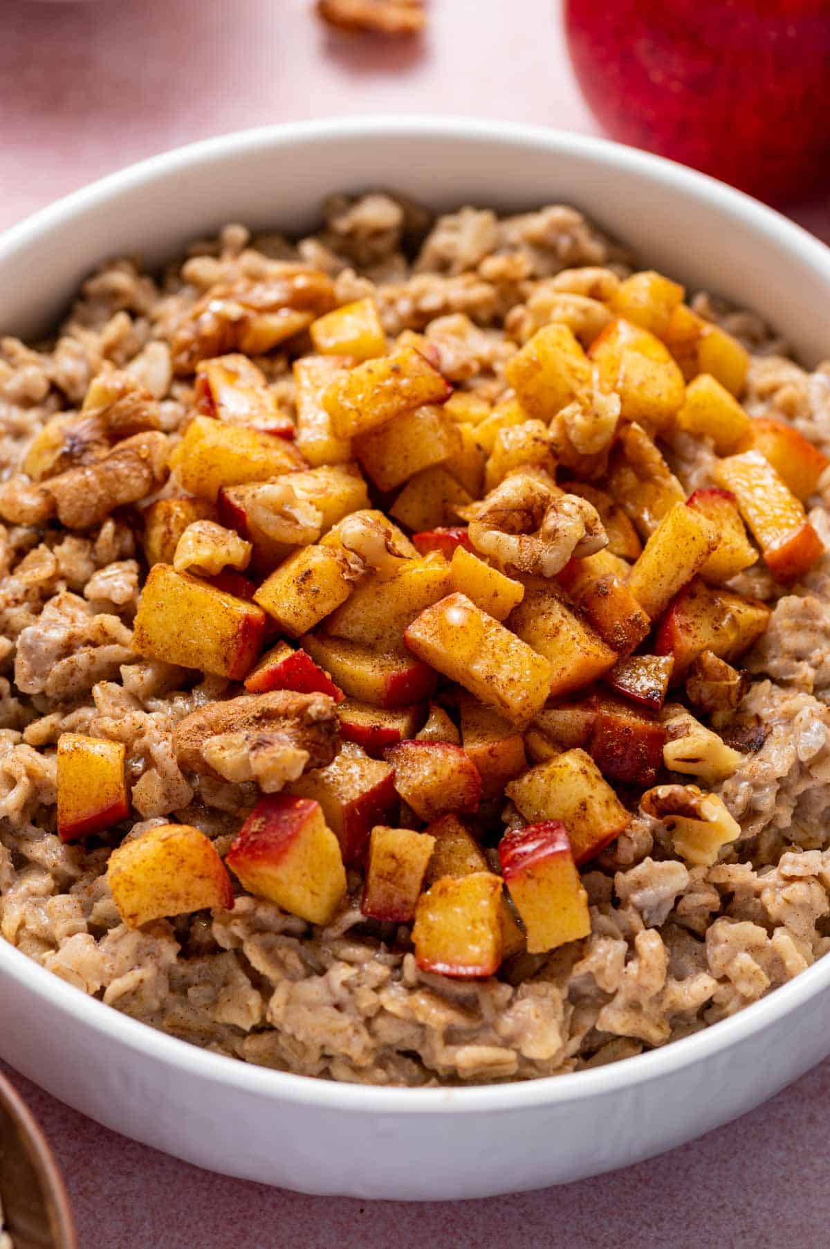 Close-up shot of apple cinnamon oatmeal showing tender oats and apples.