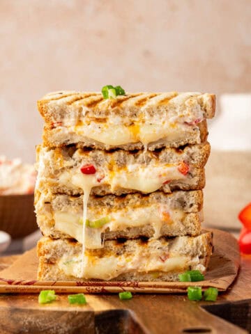 Crispy toasted bread sandwich filled with melted cream cheese and diced bell peppers.