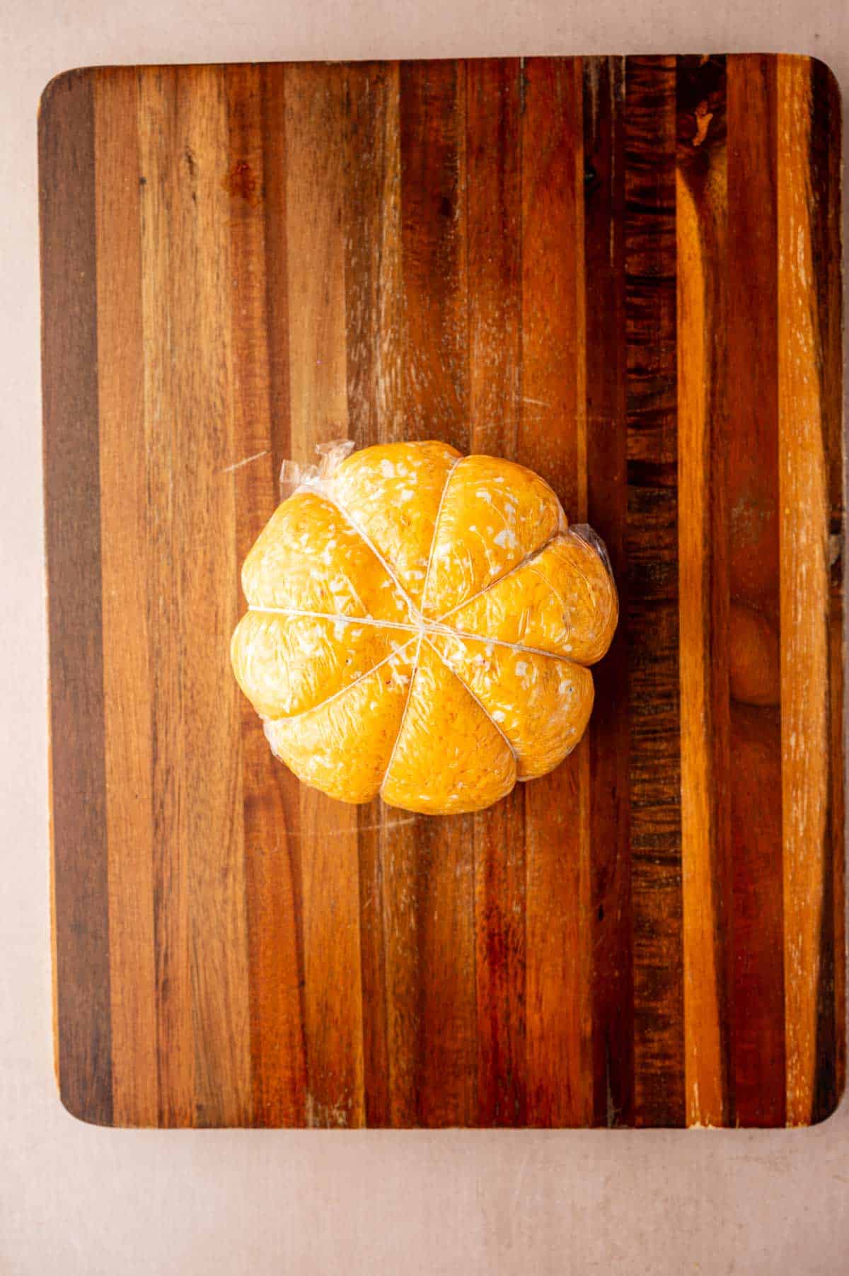 Shape to form pumpkin ridges using a thread.