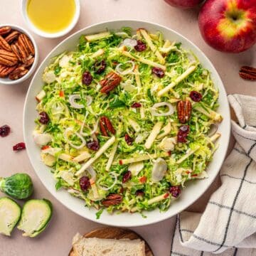 Healthy Brussels sprouts salad with maple Dijon vinaigrette, cranberries, and shallots.