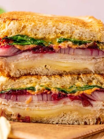 Close-up of turkey melt sandwich with cranberry relish and melted cheese, air-fried to crispy perfection.