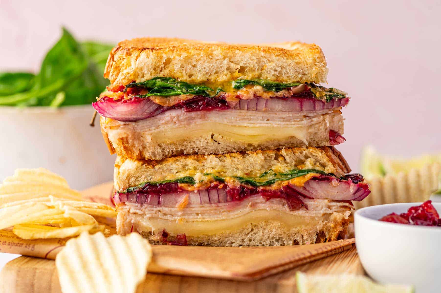 Golden, melty turkey sandwich with cranberry sauce on sourdough, cooked in an air fryer, horizontal image.