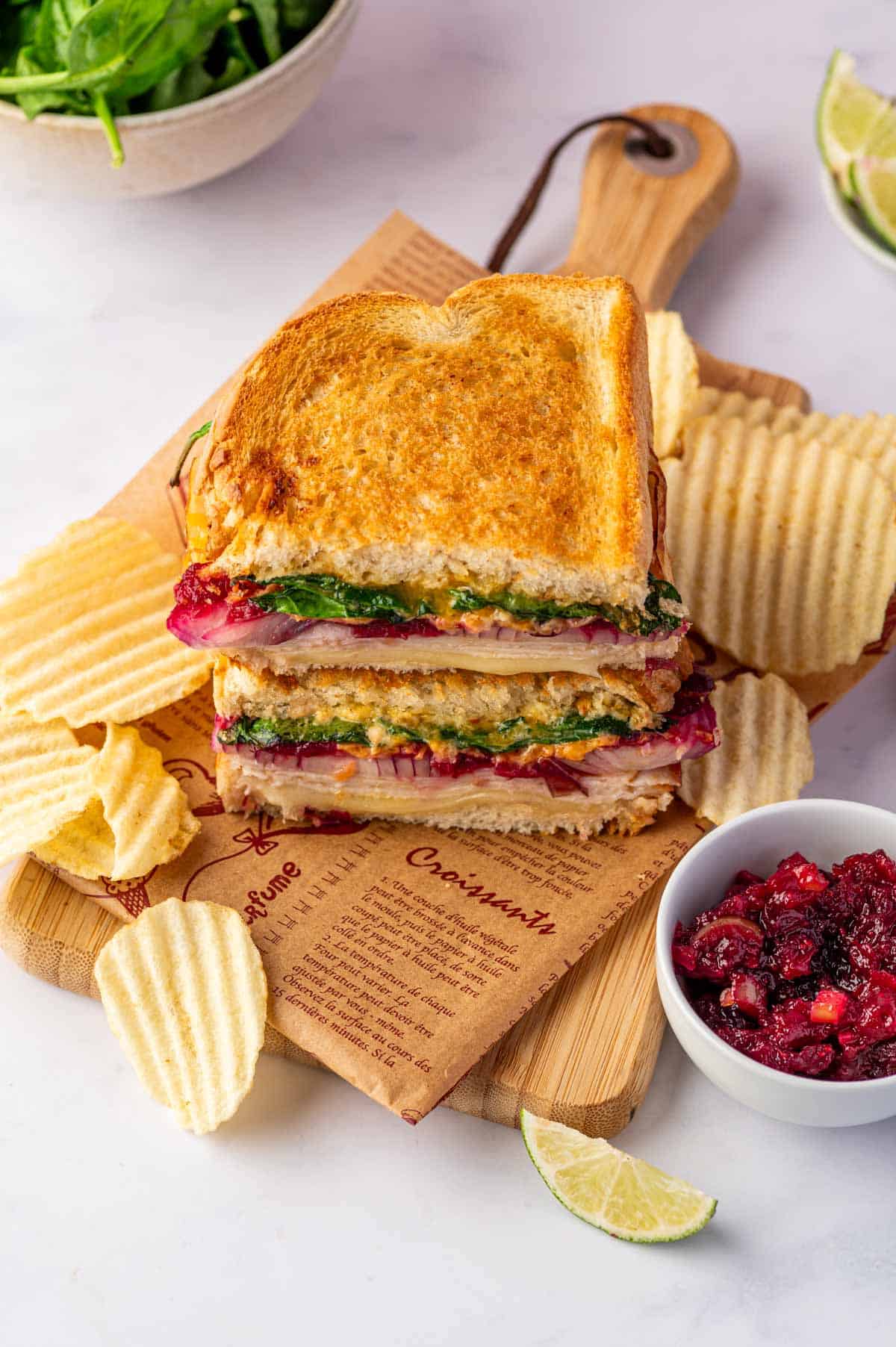 Easy air fryer turkey melt with gooey cheese and homemade cranberry relish, perfect for leftover turkey or deli turkey and chips for the sides.