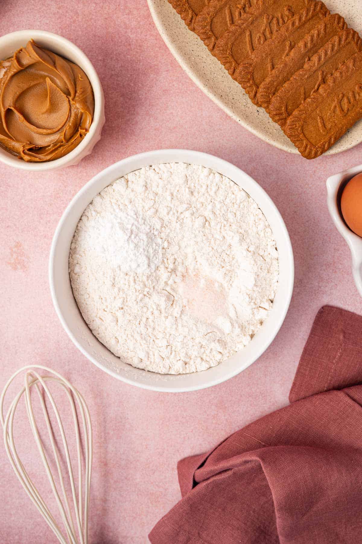 Dry ingredients being added to the bowl for making biscoff blondies