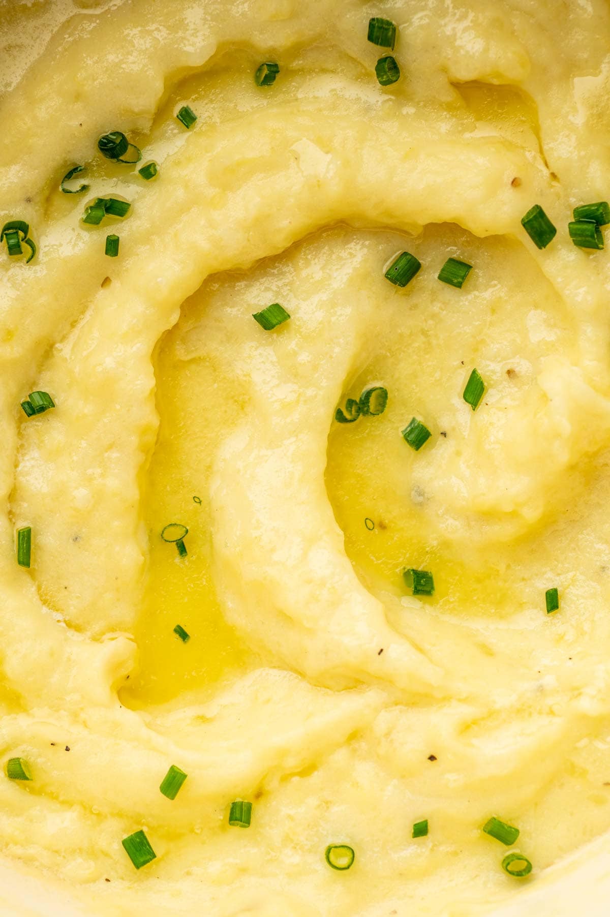 Close-up of fluffy mashed potatoes blended with cheese, garlic, and sour cream.