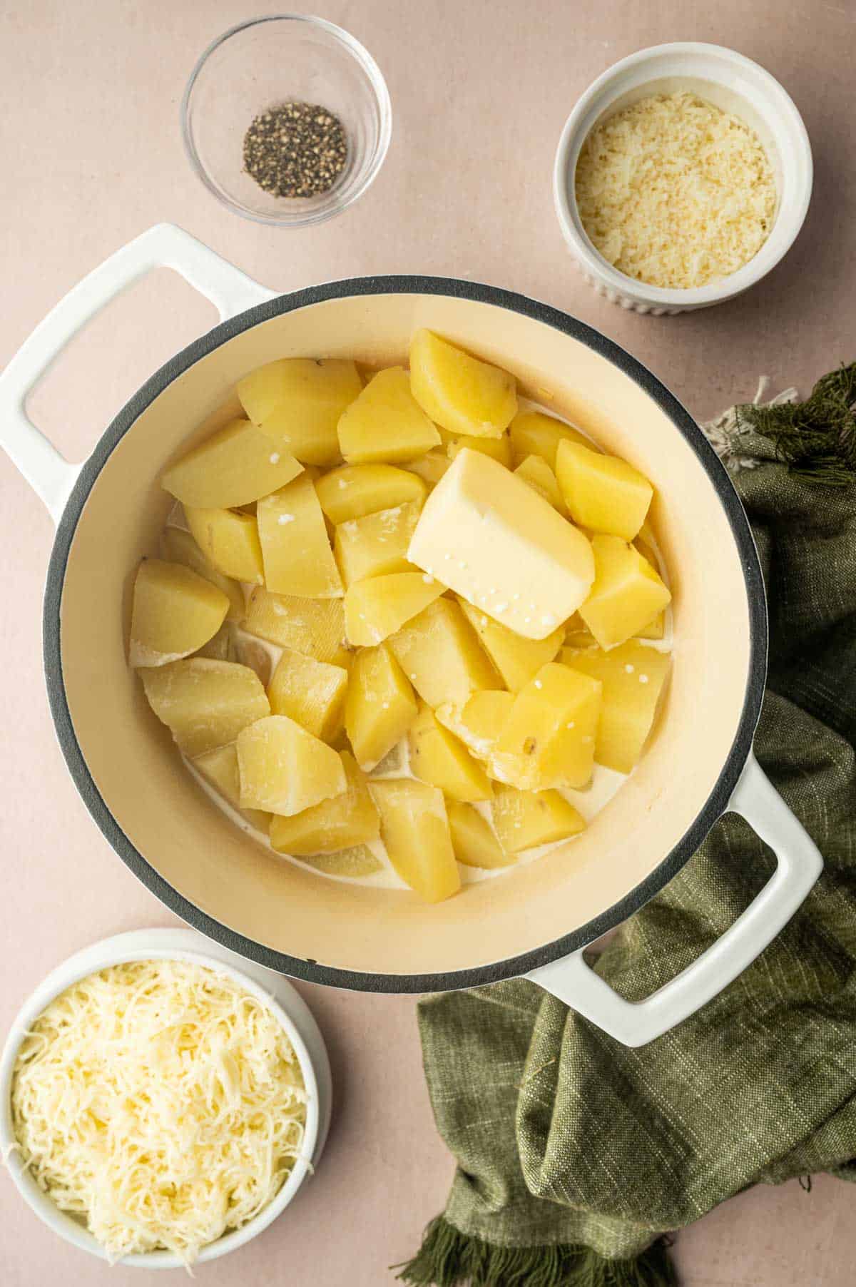 The cooked potatoes are ready to be mashed with butter.