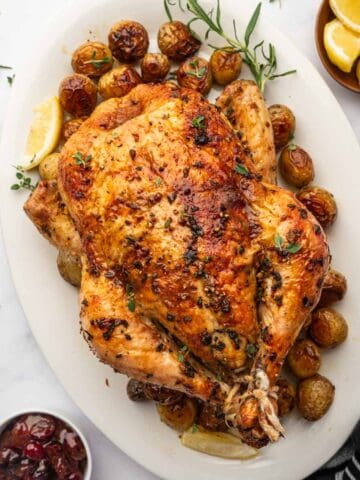 Easy oven roasted chicken and potatoes, perfectly browned and ready to serve for dinner.