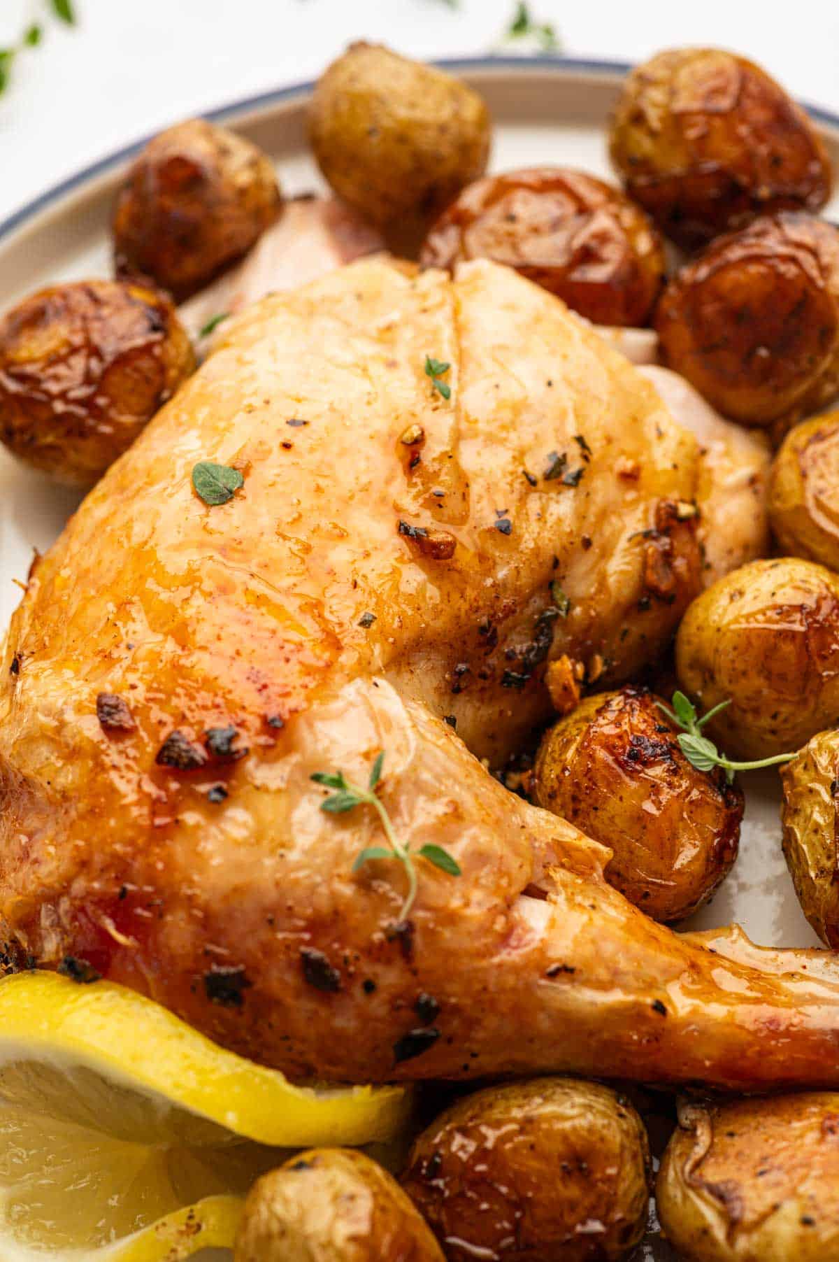 Crispy skin roasted chicken and tender potatoes baked together with rosemary and thyme.