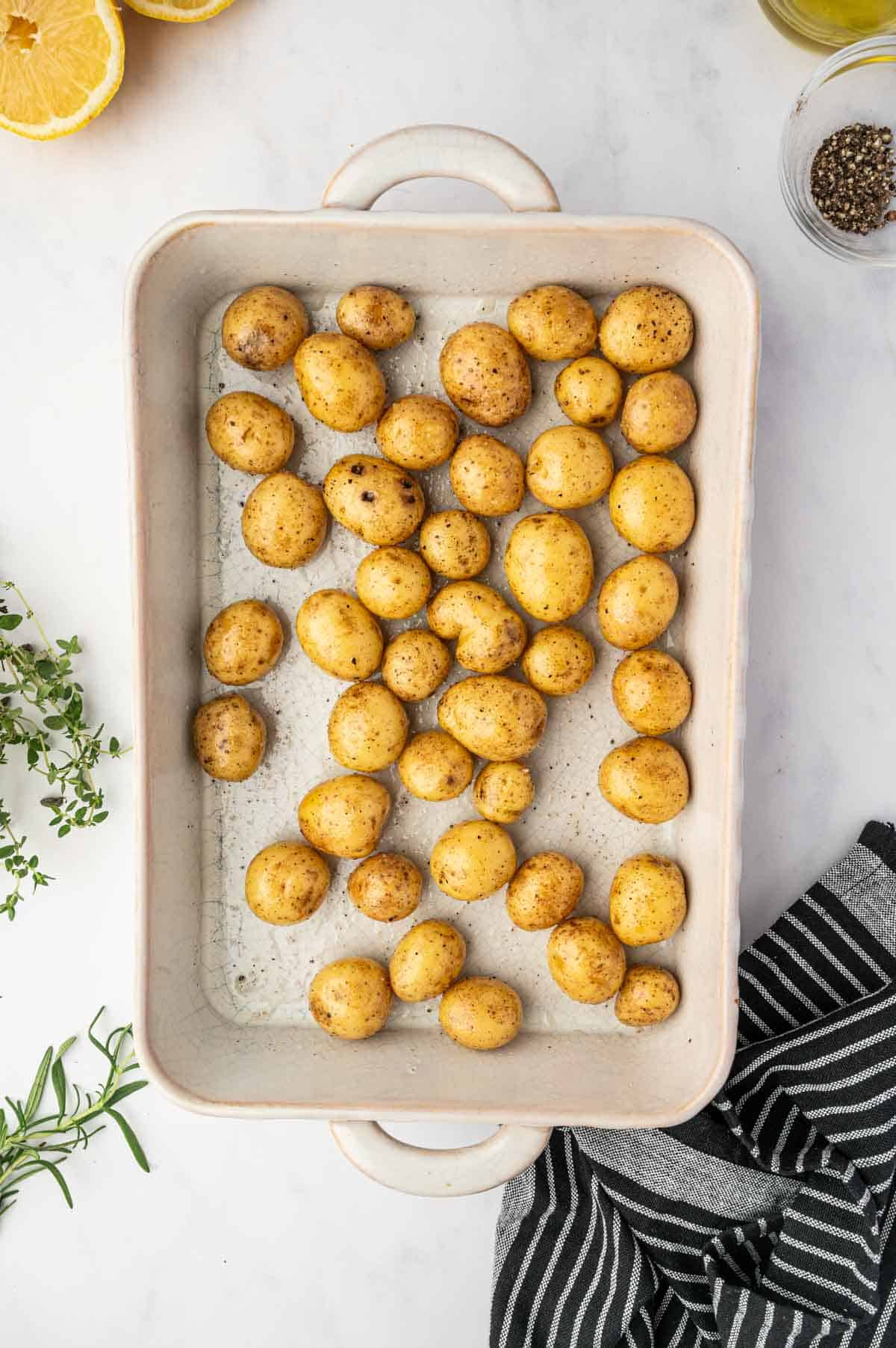 Baby potatoes being added to the casserole.