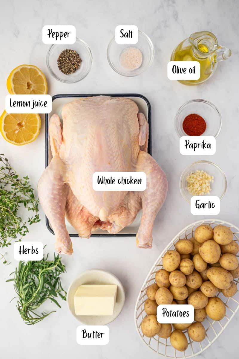 Ingredients laid out for making whole roasted chicken and potatoes 