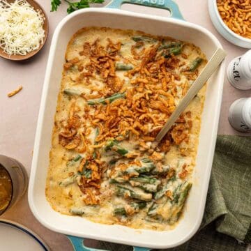 Holiday cheesy green bean casserole with golden brown top, perfect for Thanksgiving dinner.