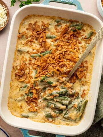 Holiday cheesy green bean casserole with golden brown top, perfect for Thanksgiving dinner.