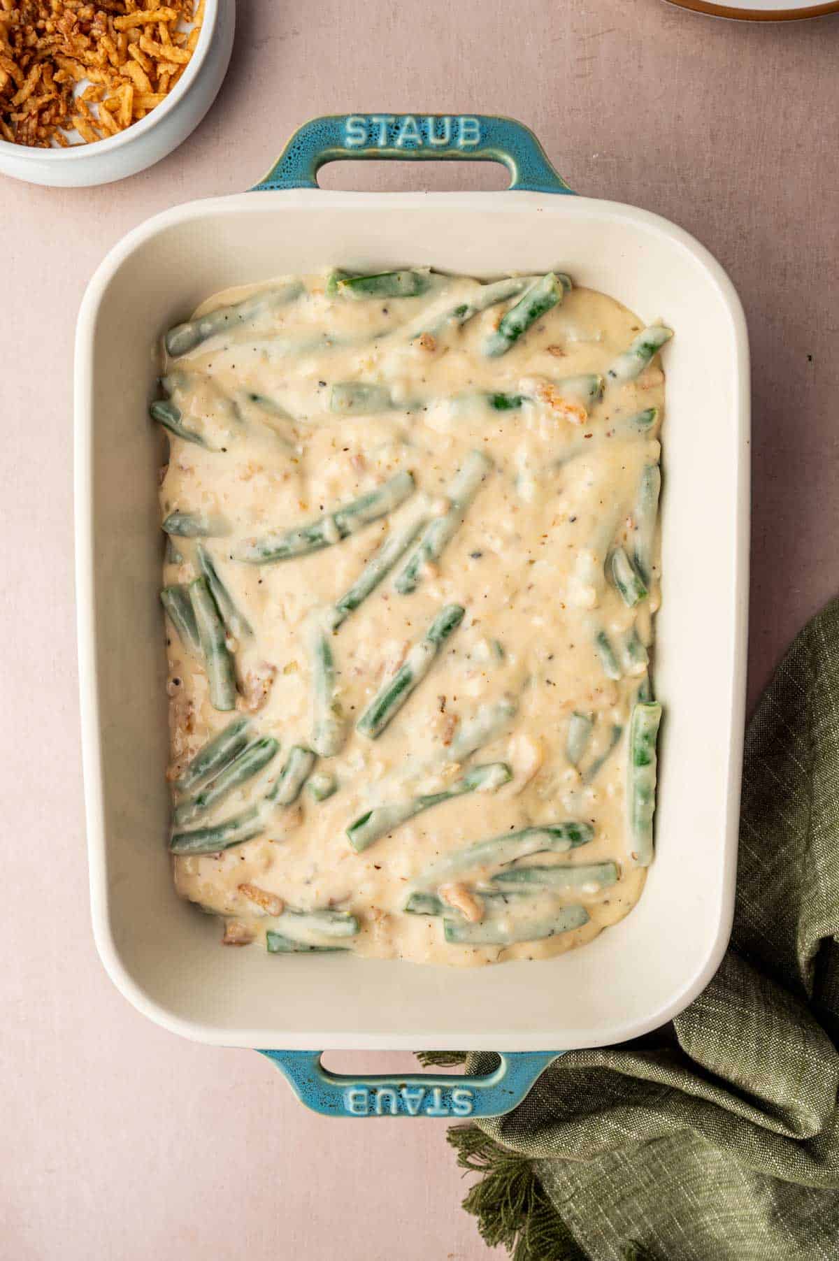 Cheesy green bean casserole is ready to be baked.