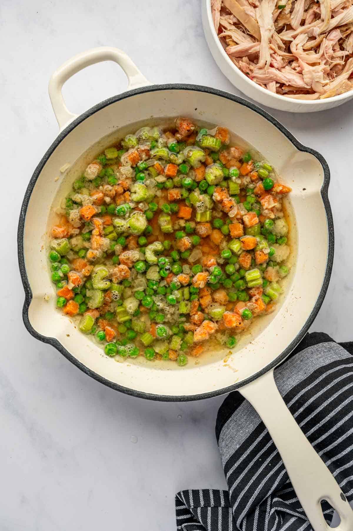 Chicken broth being added to the skillet.