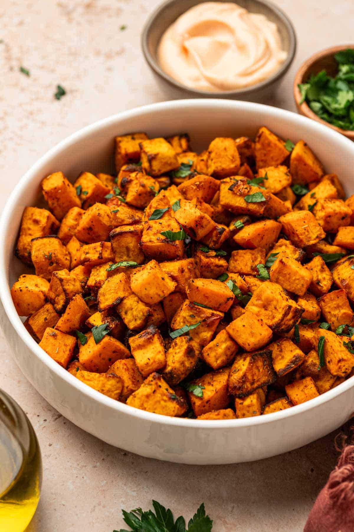Air fryer sweet potato cubes in a white bowl