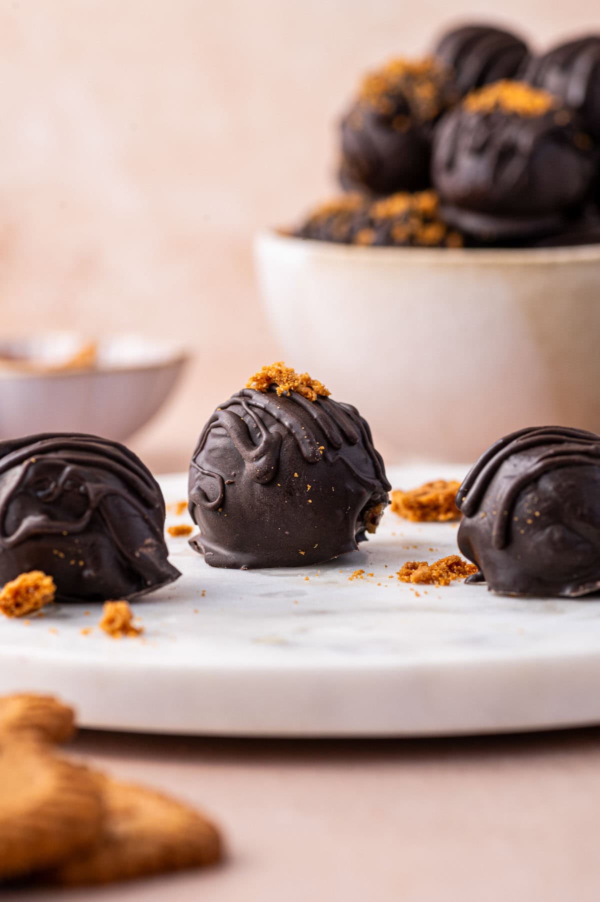 Single biscoff truffle is being focussed and some more truffles are on the bend and surroundings.