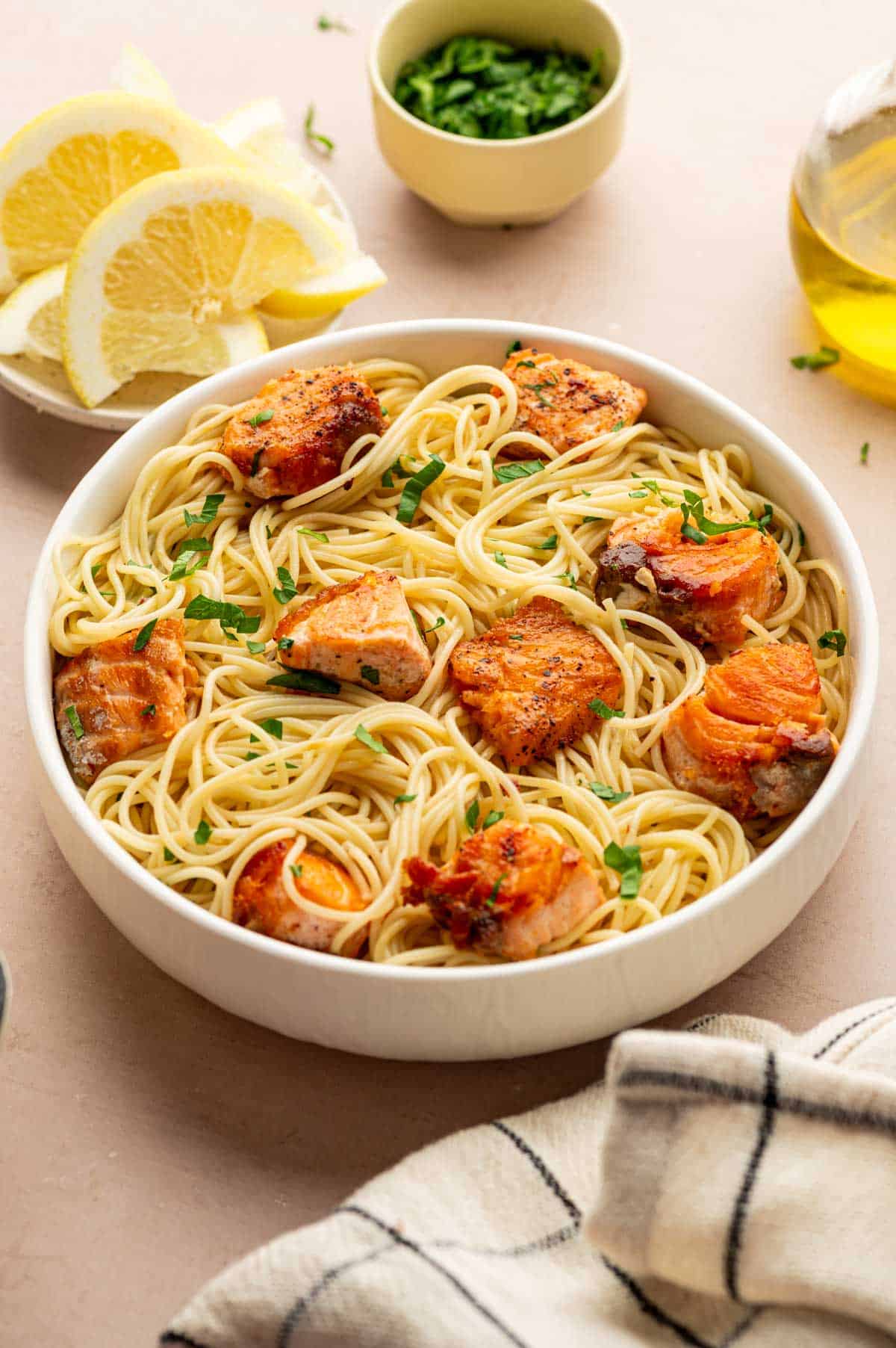 Pan-seared salmon fillets topped with scampi sauce and lemon slices