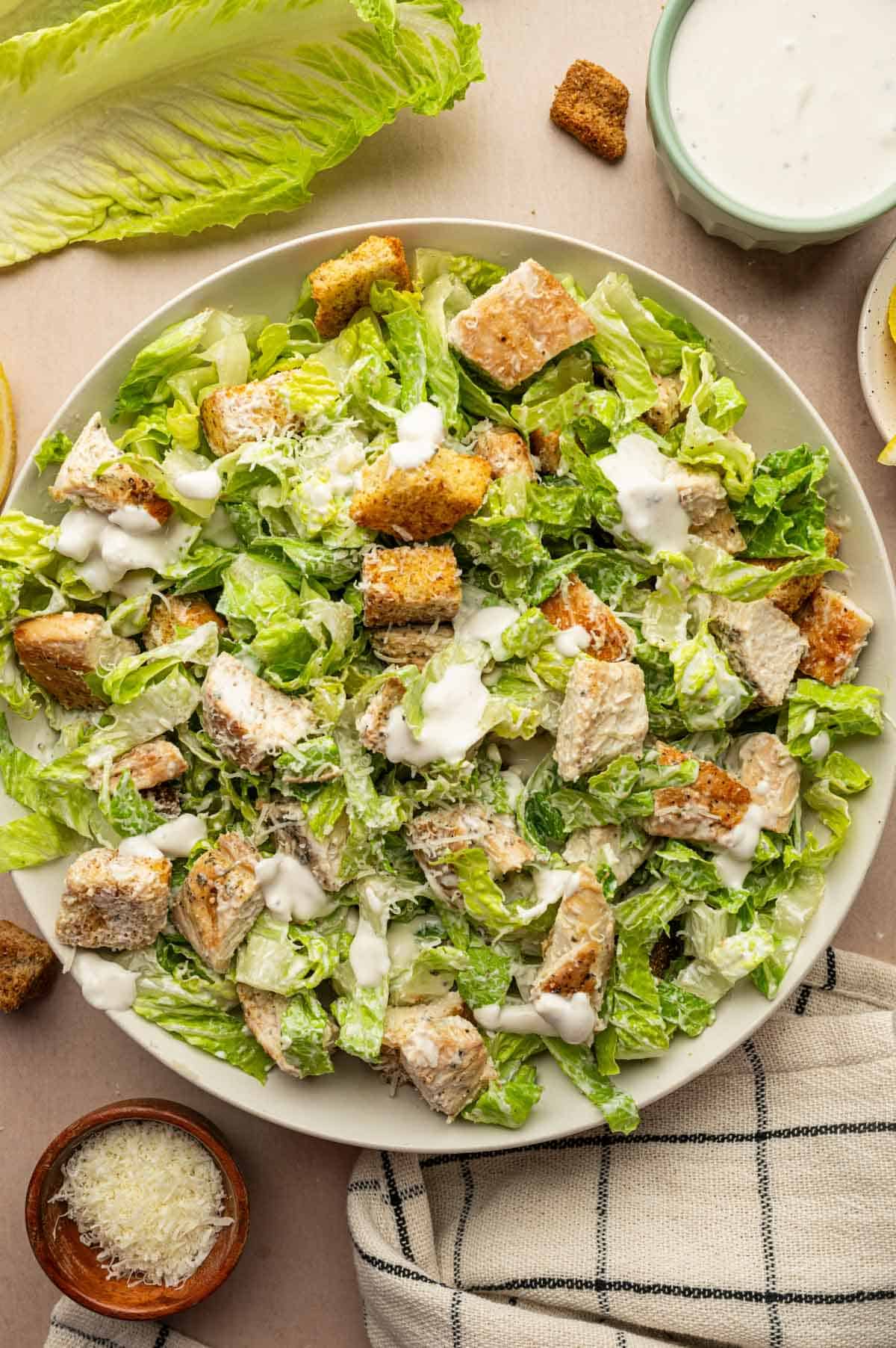 Chicken Caesar Salad with grilled chicken, crunchy croutons, and shaved Parmesan in a large bowl