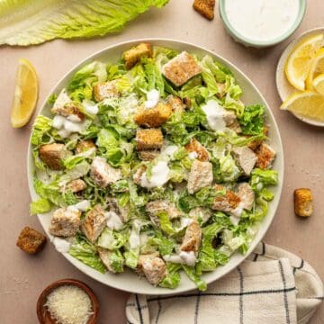 Overhead shot of Chicken Caesar Salad with crispy croutons and low calorie greek yogurt dressing.