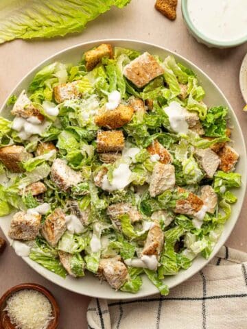 Overhead shot of Chicken Caesar Salad with crispy croutons and low calorie greek yogurt dressing.