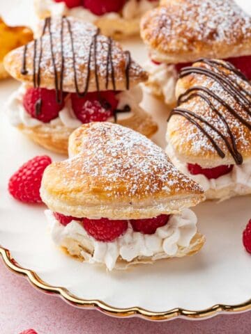 Baked puff pastry hearts with flaky, layered edges.
